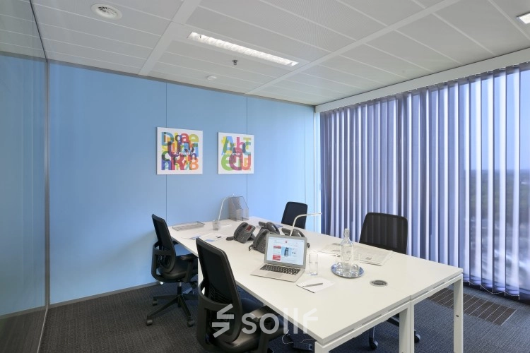 Modern office space in Brussels Elsene at Louizalaan / Avenue Louise 65, featuring a bright interior with a large desk and chairs, ideal for office space rental.