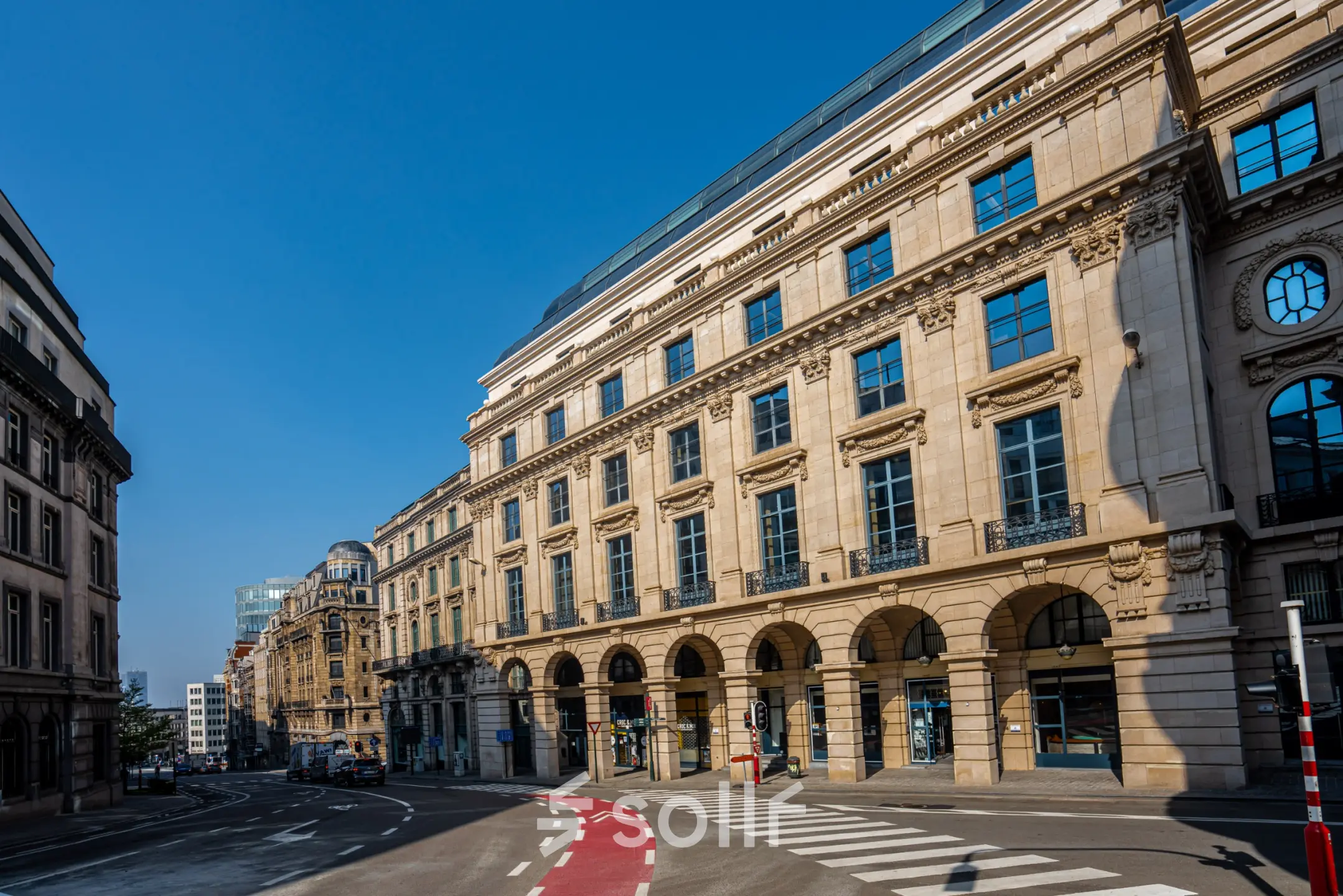 Street view of a classic European office building at Rue des Colonies 56, ideal for office space rental in Brussels' European District.