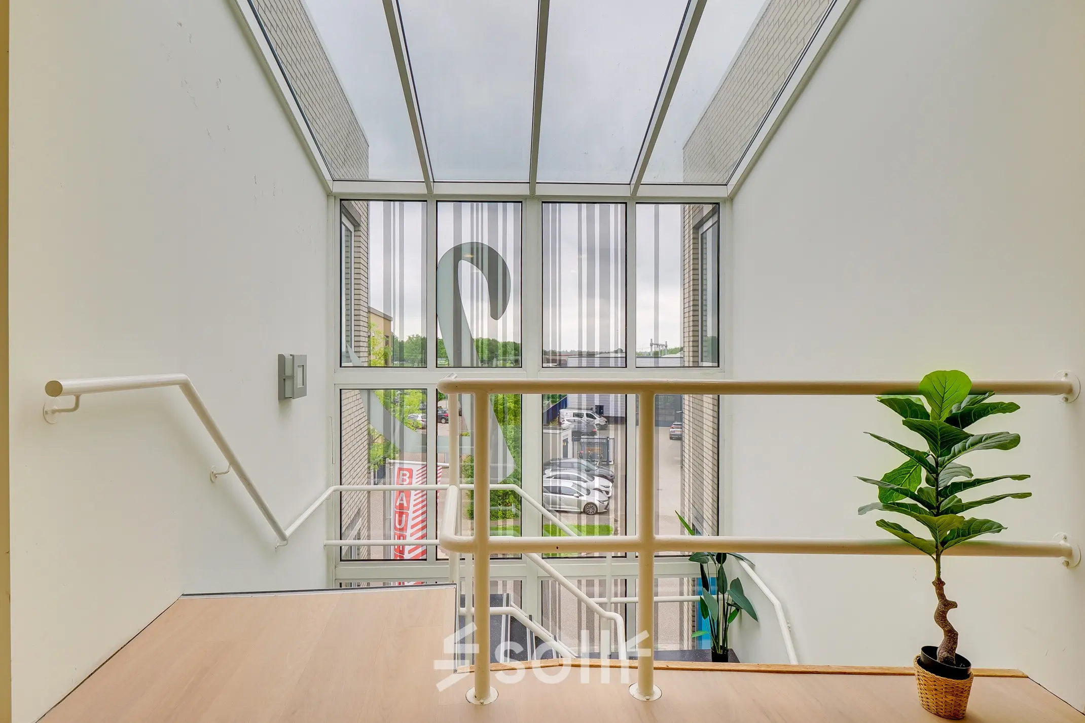 Bright office entrance with large windows at Regulierenring 2, Bunnik, perfect for those seeking office space rental.