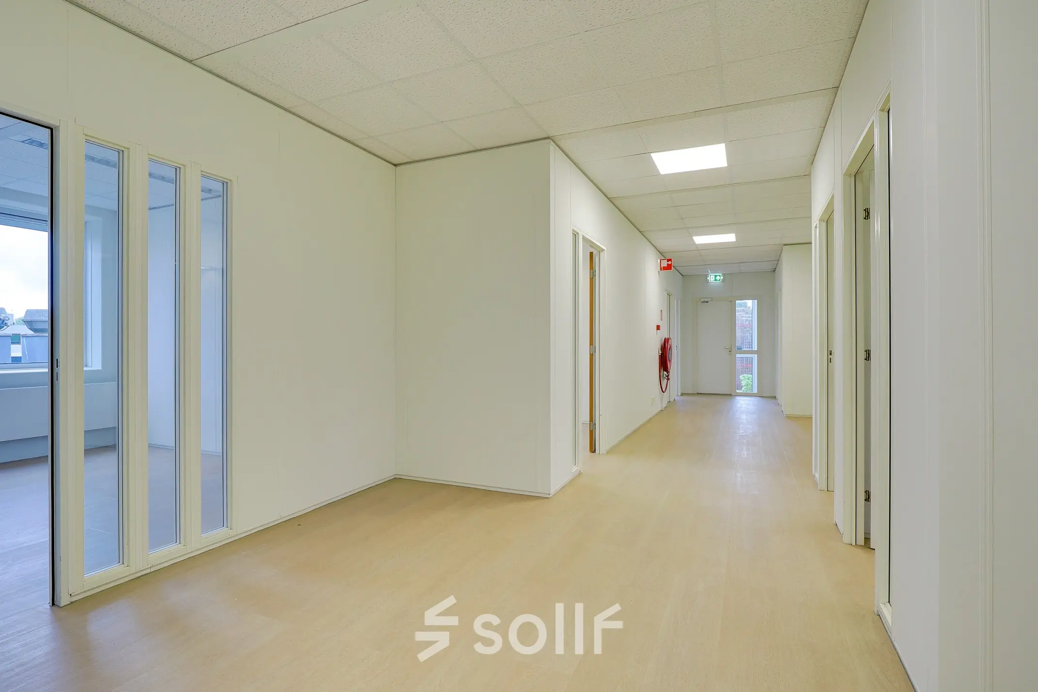 Bright hallway in an office space to rent at Regulierenring 2, Bunnik, with light wood flooring and white walls.