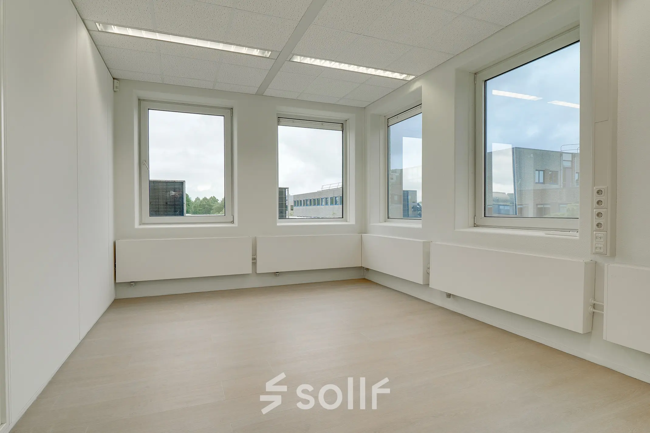 Bright office space for rent at Regulierenring 2, Bunnik, featuring large windows and ample natural light.