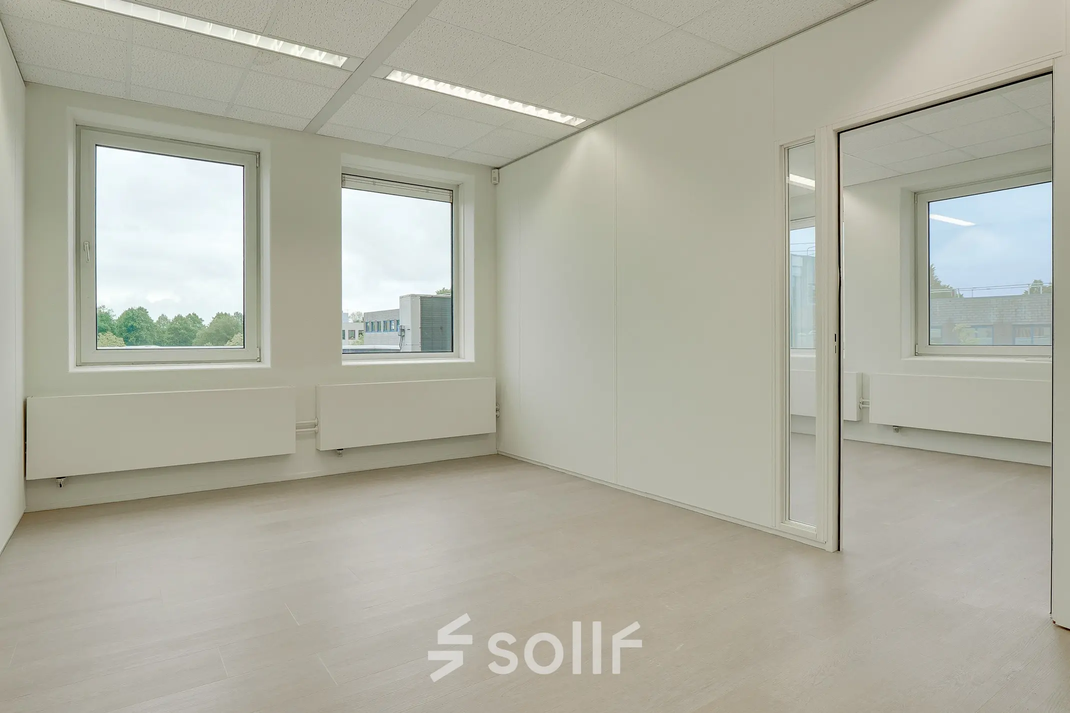 Bright office space with large windows and neutral tones, located at Regulierenring 2, Bunnik. Ideal for office space rental.
