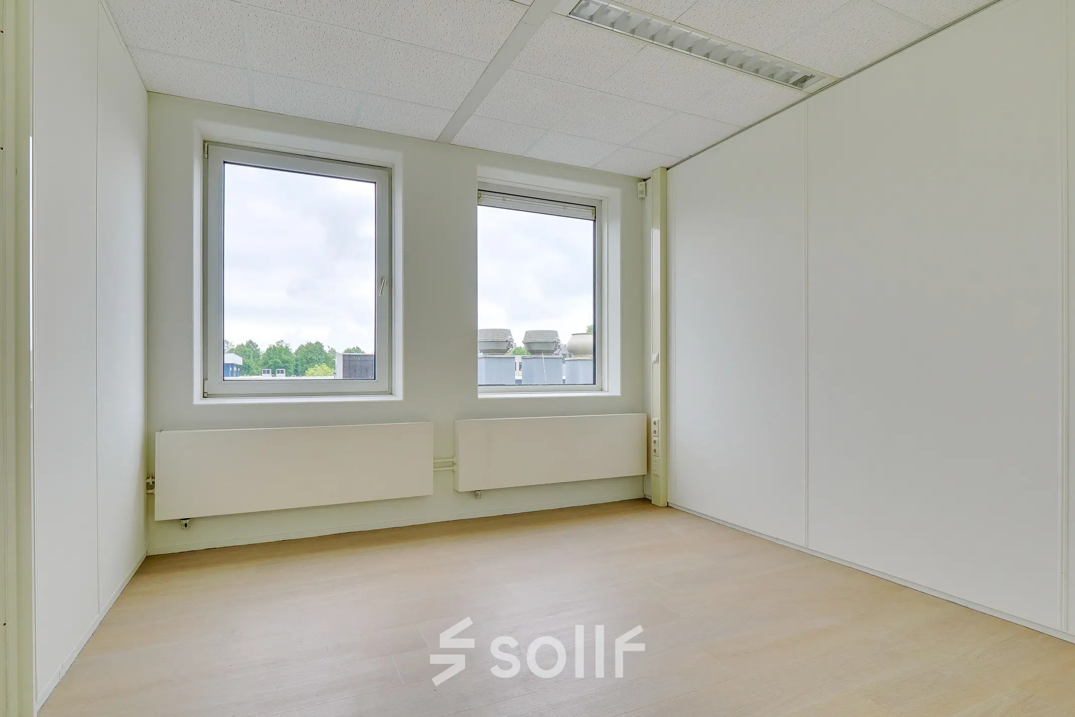 Bright office space for rent at Regulierenring 2, Bunnik, featuring large windows and ample natural light.