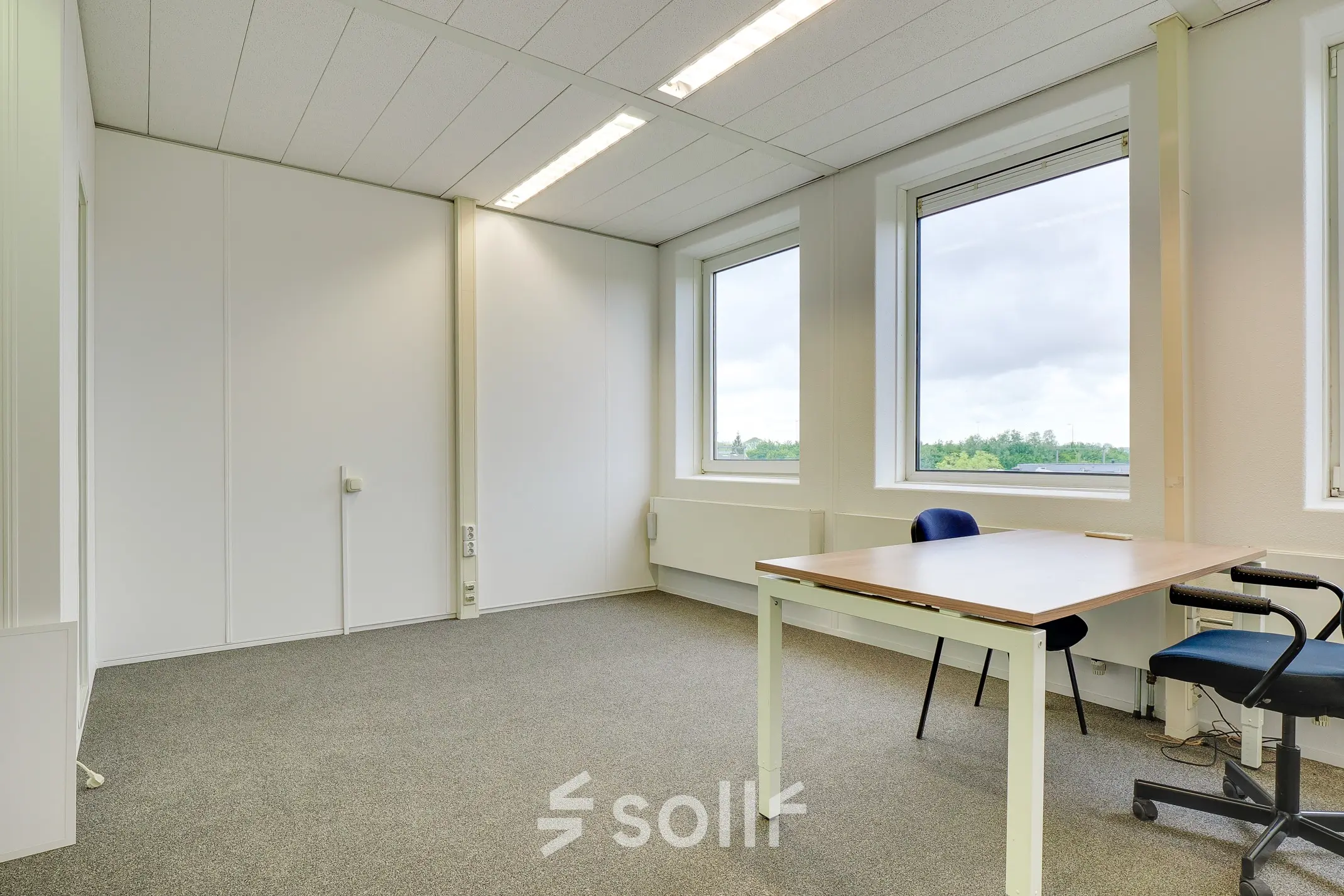 Spacious office room with large windows offering natural light and views of Bunnik greenery. Ideal for rent office space for professionals seeking calm and focus.