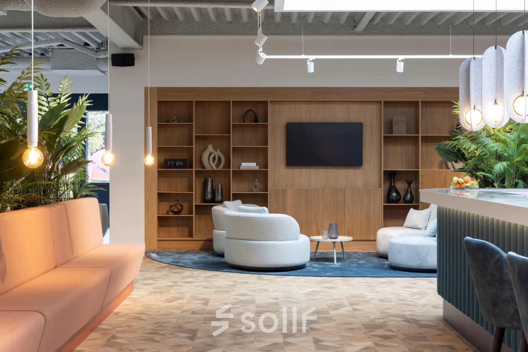 Modern office lounge at Essebaan 63 in Capelle aan den IJssel, featuring stylish seating and a large wall-mounted screen, suitable for office space rental.