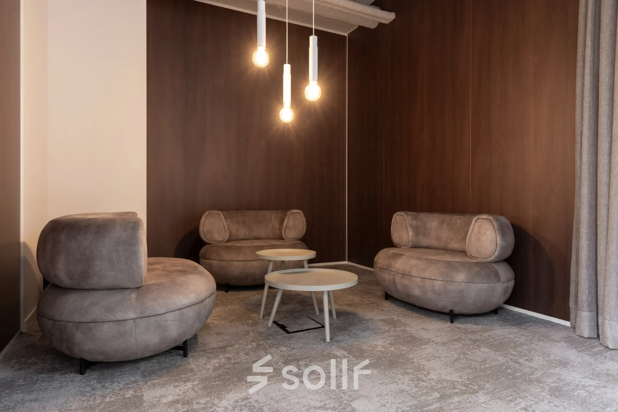 Furnished office lounge area with modern brown sofas and round tables, ideal for office space rental at Essebaan 63, Capelle aan den IJssel.