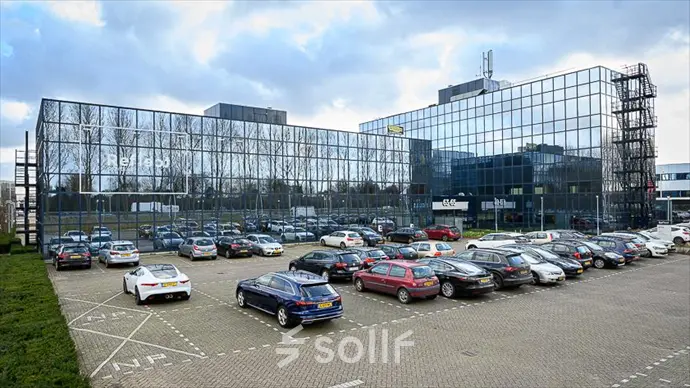 Exterior view of the modern office building at Essebaan 63, Capelle aan den IJssel, showcasing the parking area. Ideal for businesses looking for office space rental.