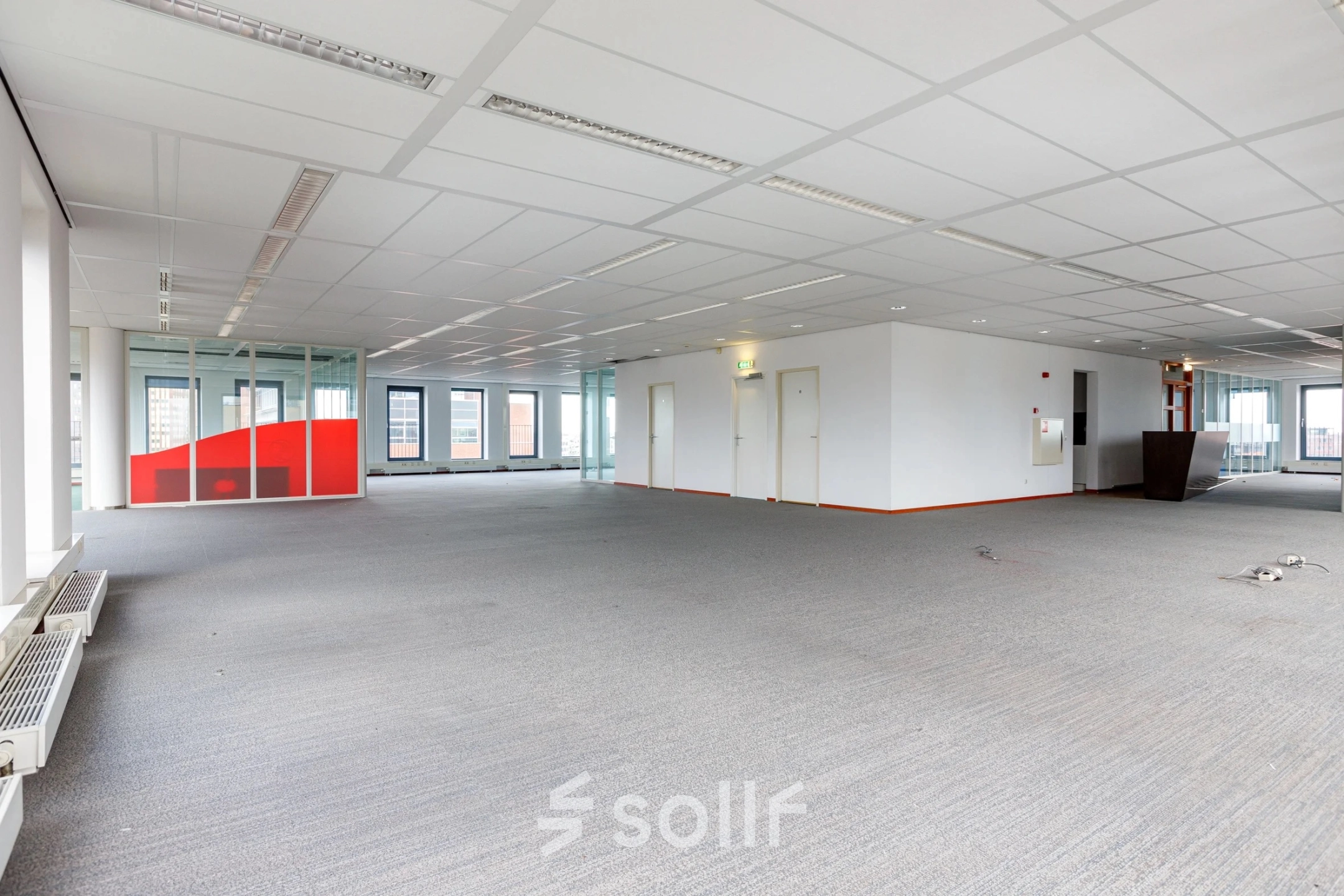Spacious interior of an office to rent at Fascinatio Boulevard 562, Capelle aan den IJssel, featuring large windows and a neutral color scheme, ready for office space rental customization.