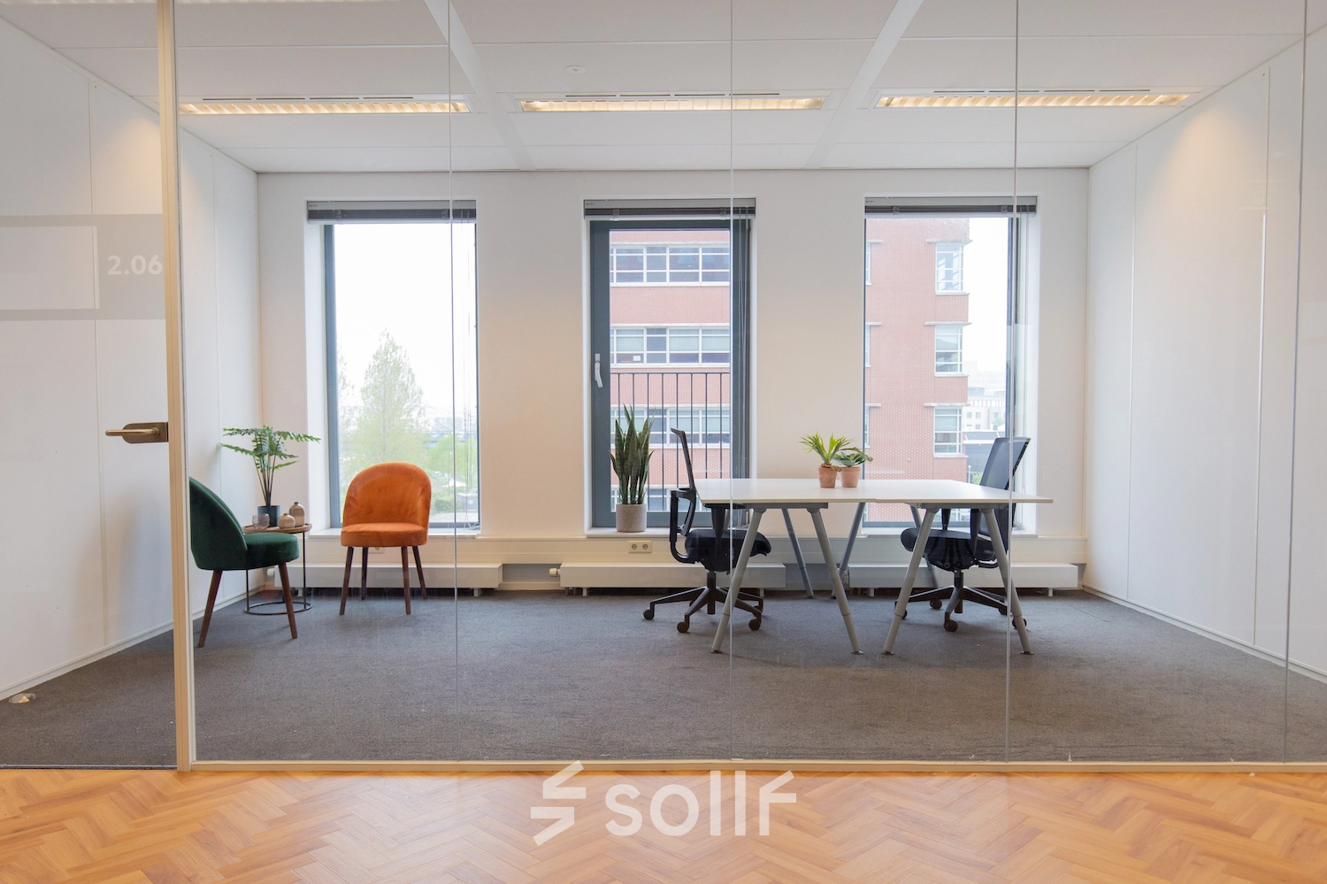 Furnished office space with desks, chairs, and plants at Fascinatio Boulevard 562 in Capelle aan den IJssel, available for rent. Large windows offer natural light.