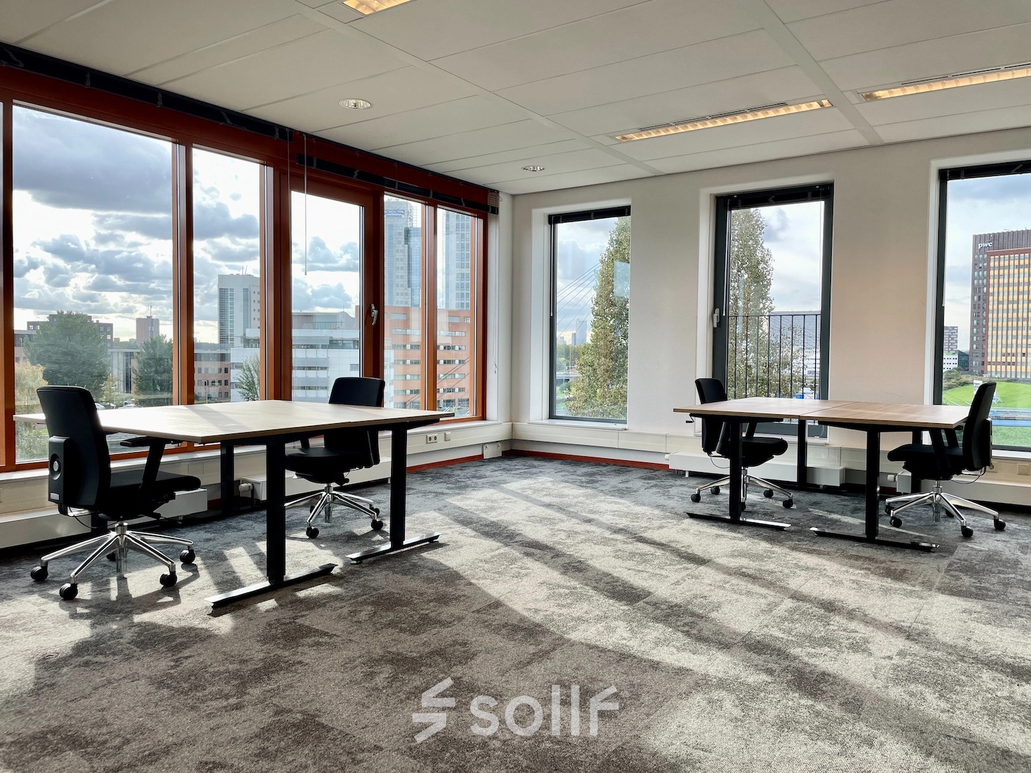 Bright and airy office interior at Fascinatio Boulevard 562 in Capelle aan den IJssel, featuring large windows, two modern desks with chairs, available for office space rental.