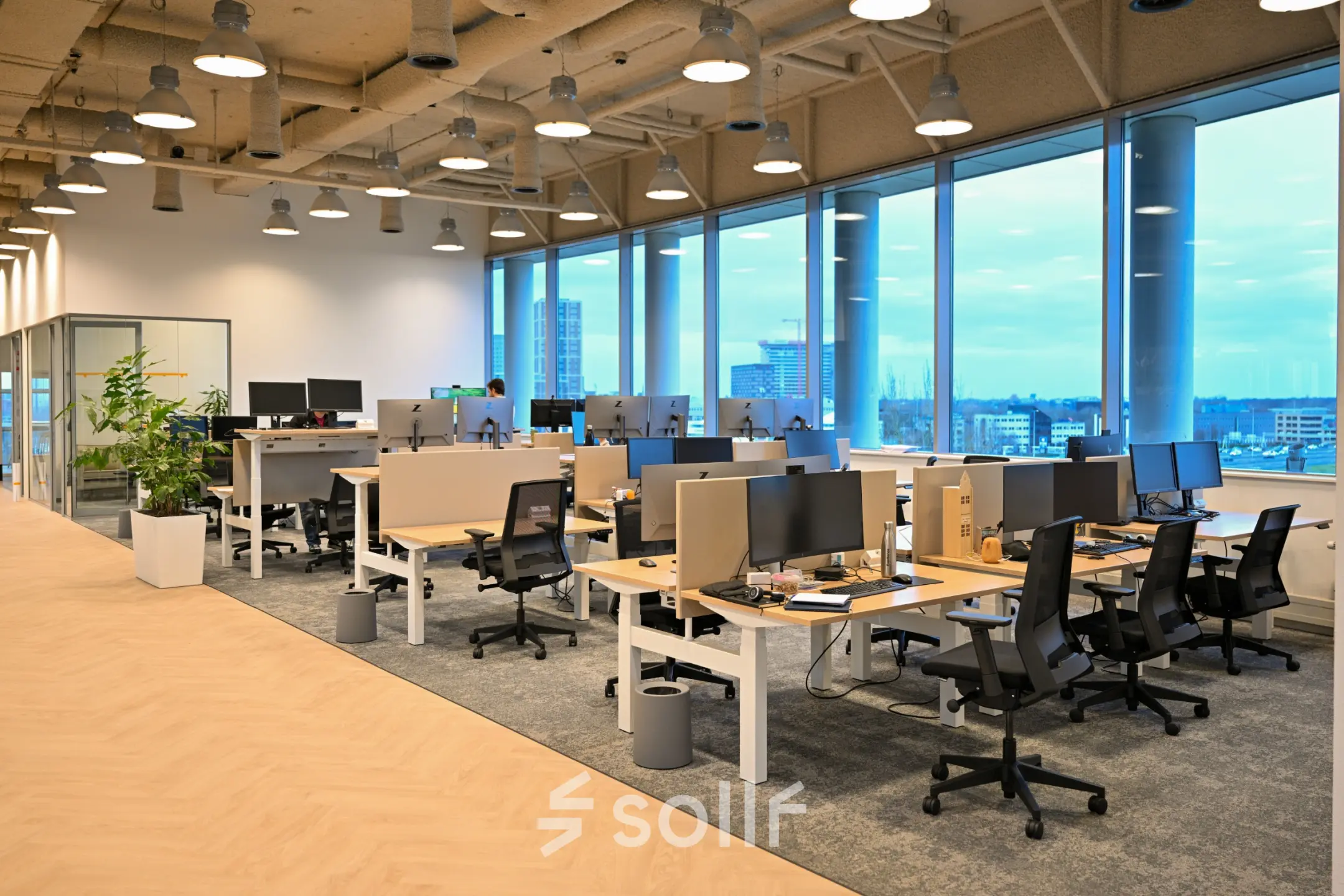 Spacious open office with multiple workstations, large windows providing natural light at Rivium Quadrant 75. Ideal for office space rental in Capelle aan den IJssel.