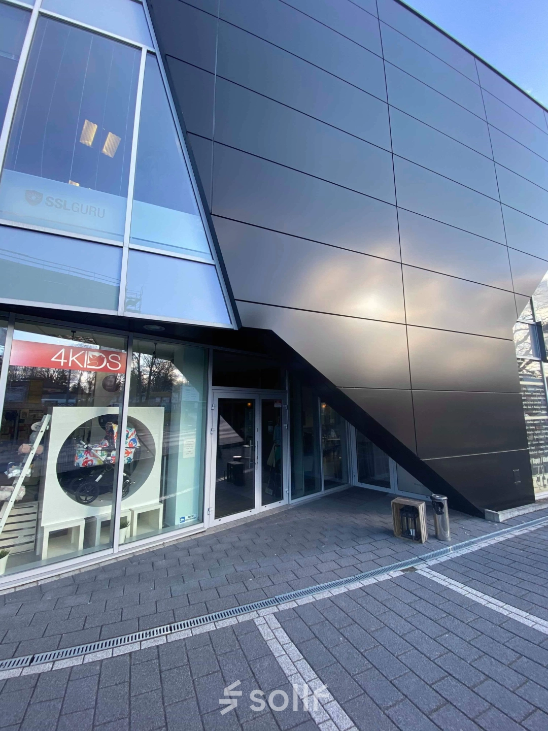 Modern exterior view of an office space available for rent at Marcika 27, Cracow Łagiewniki Borek Fałęcki, featuring sleek architecture and large windows.