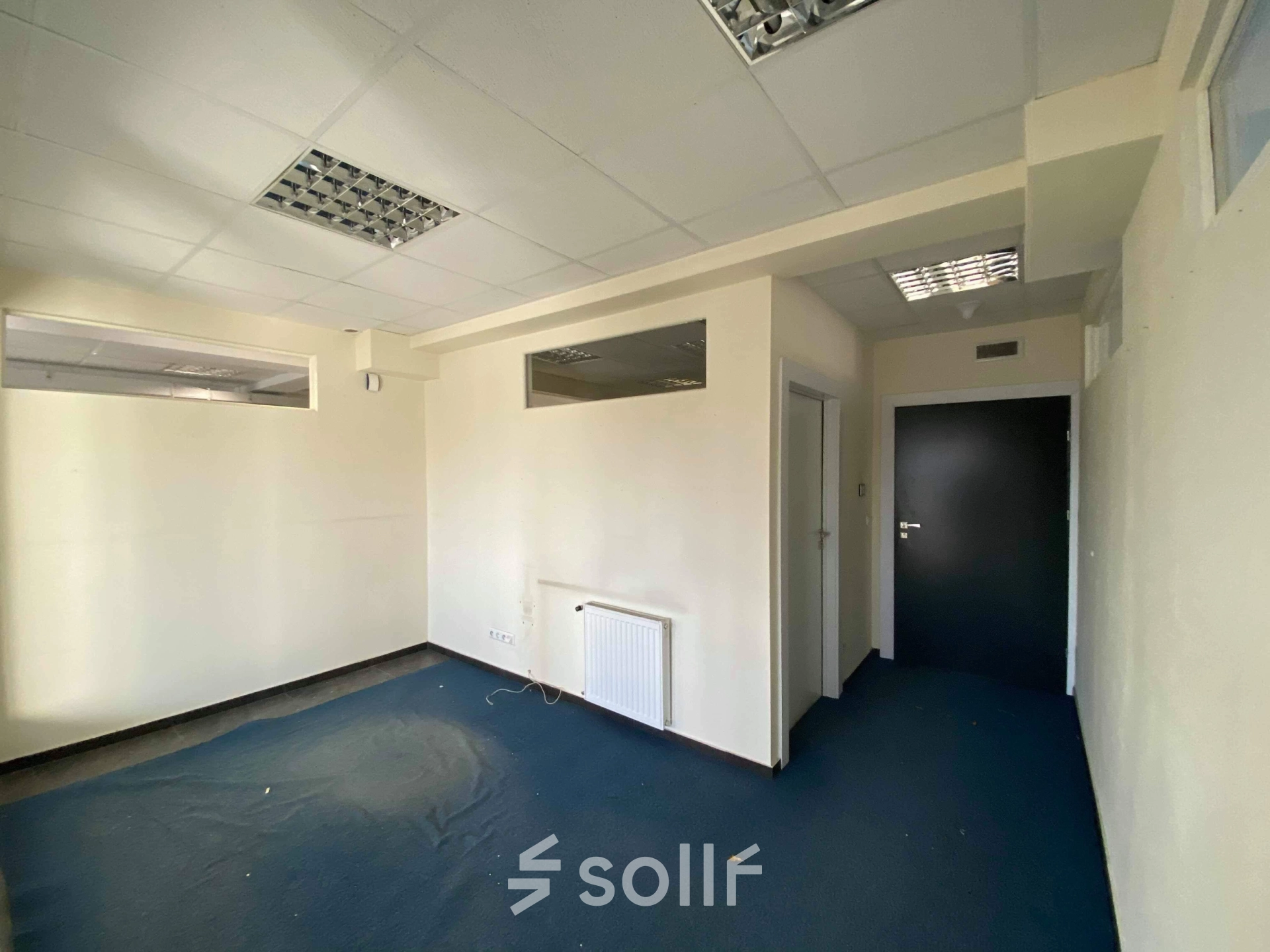 Unfurnished office space available for rent at Marcika 27, Cracow Łagiewniki Borek Fałęcki, featuring modern lighting and potential for customization in a well-lit environment.
