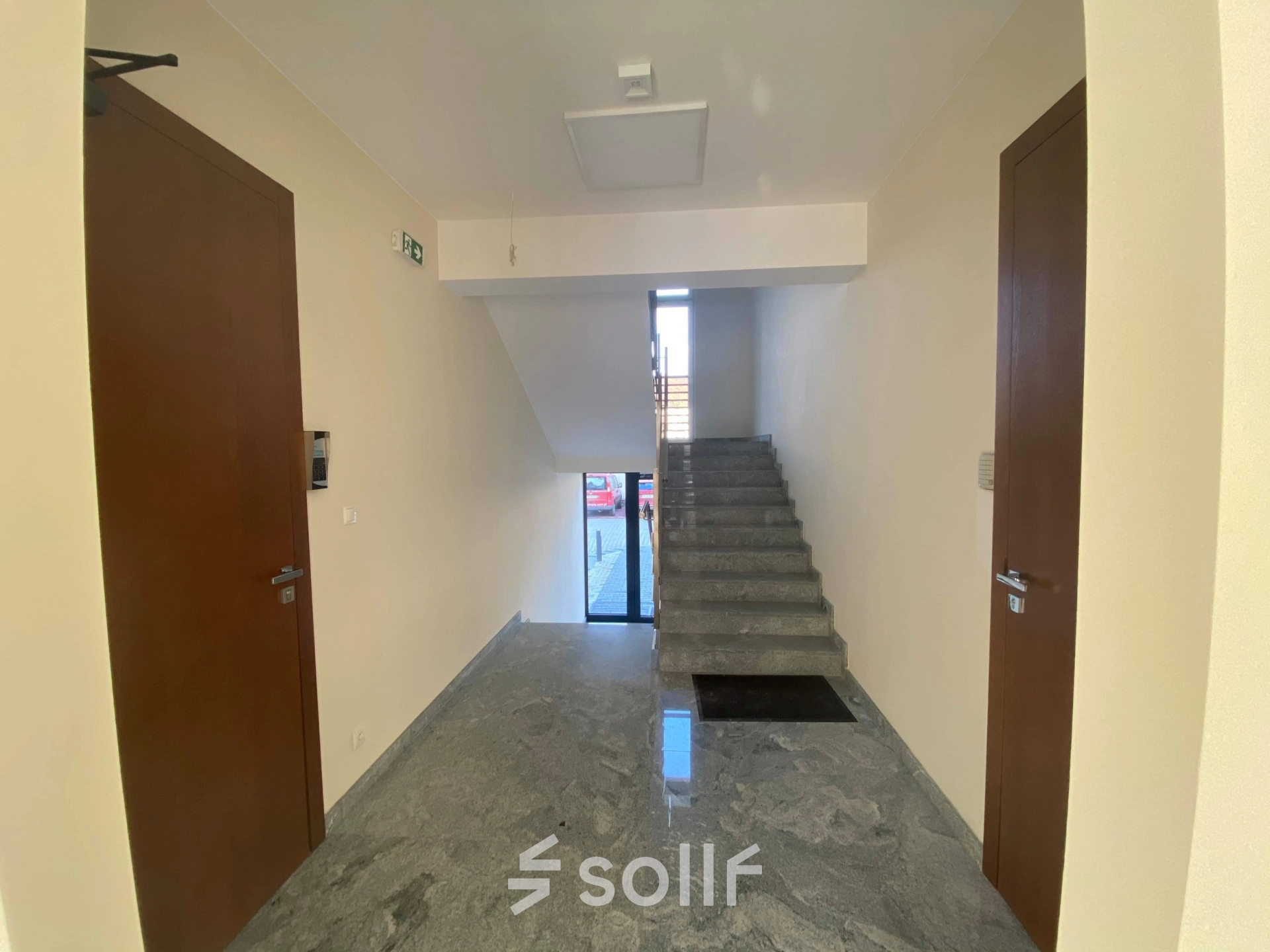 Entrance hallway at Jastrzębia 24, Cracow Podgorze Duchackie, featuring marble flooring and wooden doors, ideal for rent office space needs.