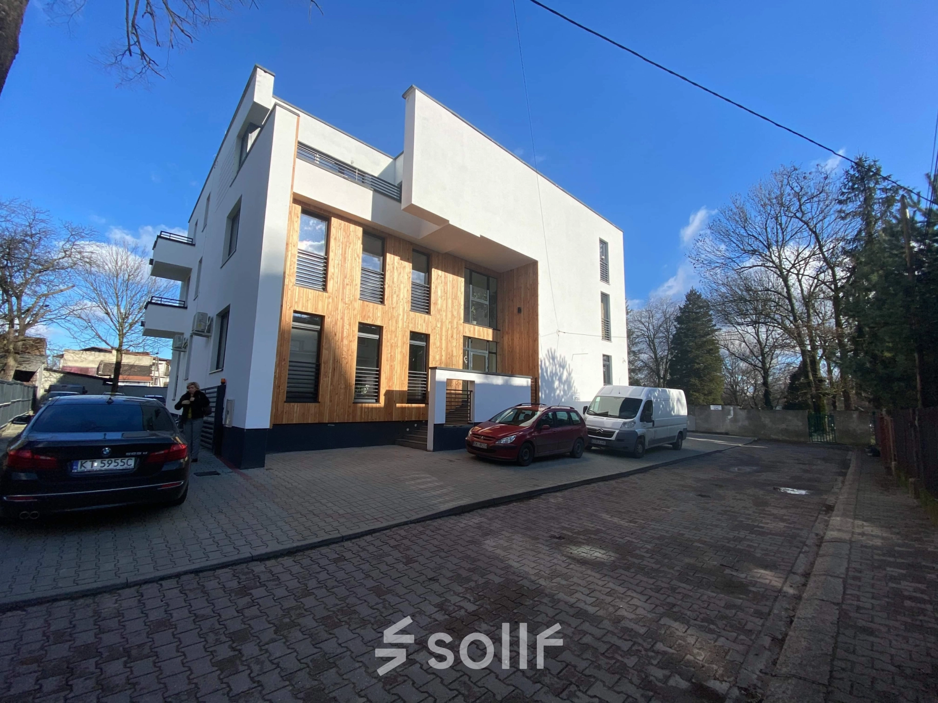 The exterior of a modern office building at Jastrzębia 24, Cracow Podgorze Duchackie, featuring clean lines and parking space. Ideal for office space rental.
