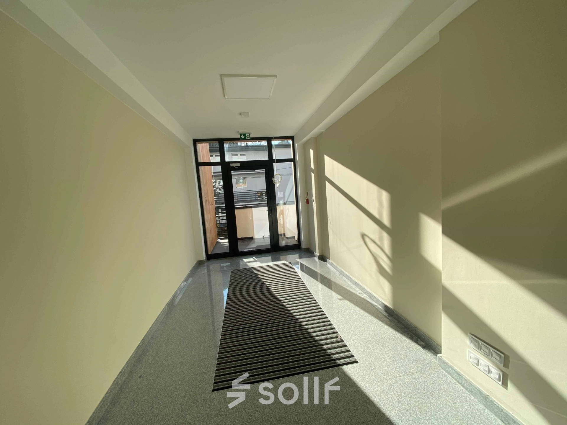 Bright entrance hallway of an office space with large glass doors at Jastrzębia 24, Cracow Podgorze Duchackie, ideal for office space rental.