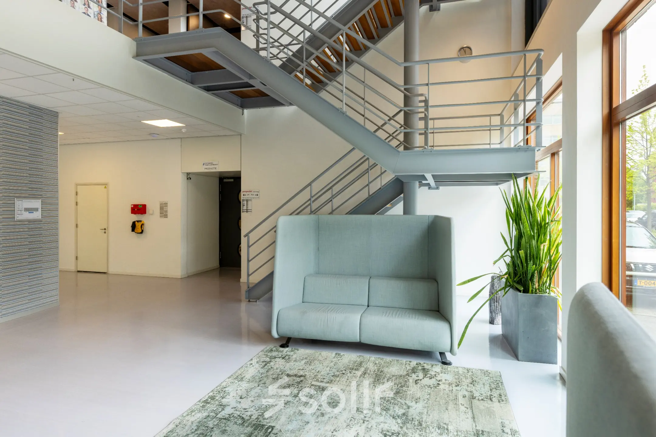 Modern office space rental at Delftechpark 9 in Delft, featuring sleek staircase and comfortable seating, ideal for businesses looking to rent office space.