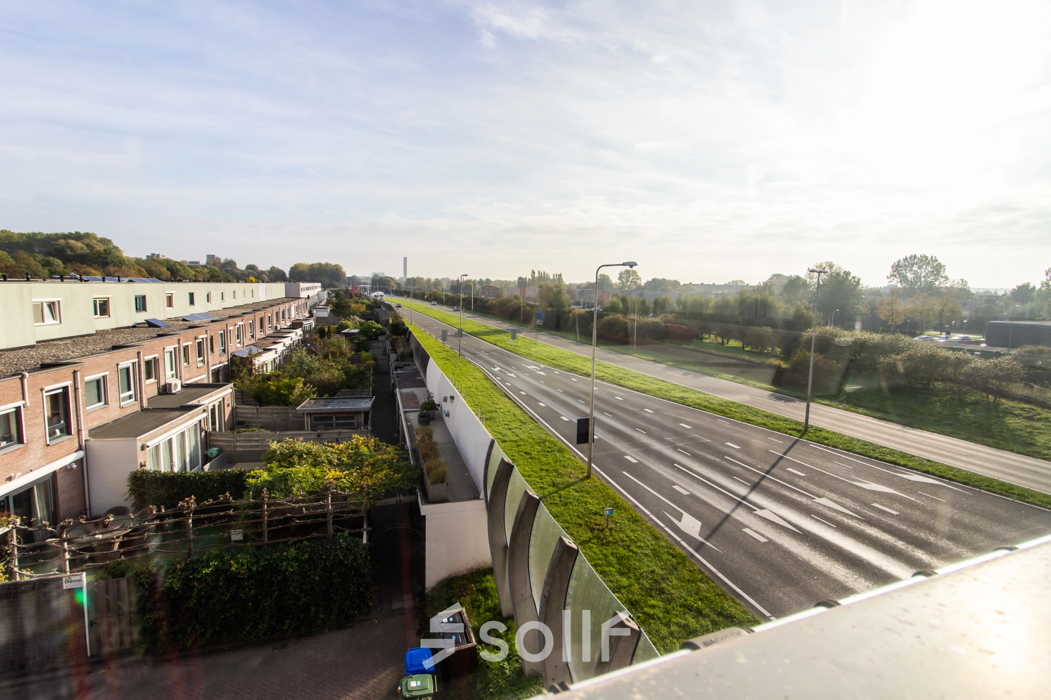 Exterior view of Marshalllaan 2 in Delft showing a peaceful roadside environment, ideal for those seeking office space rental with ease of access.