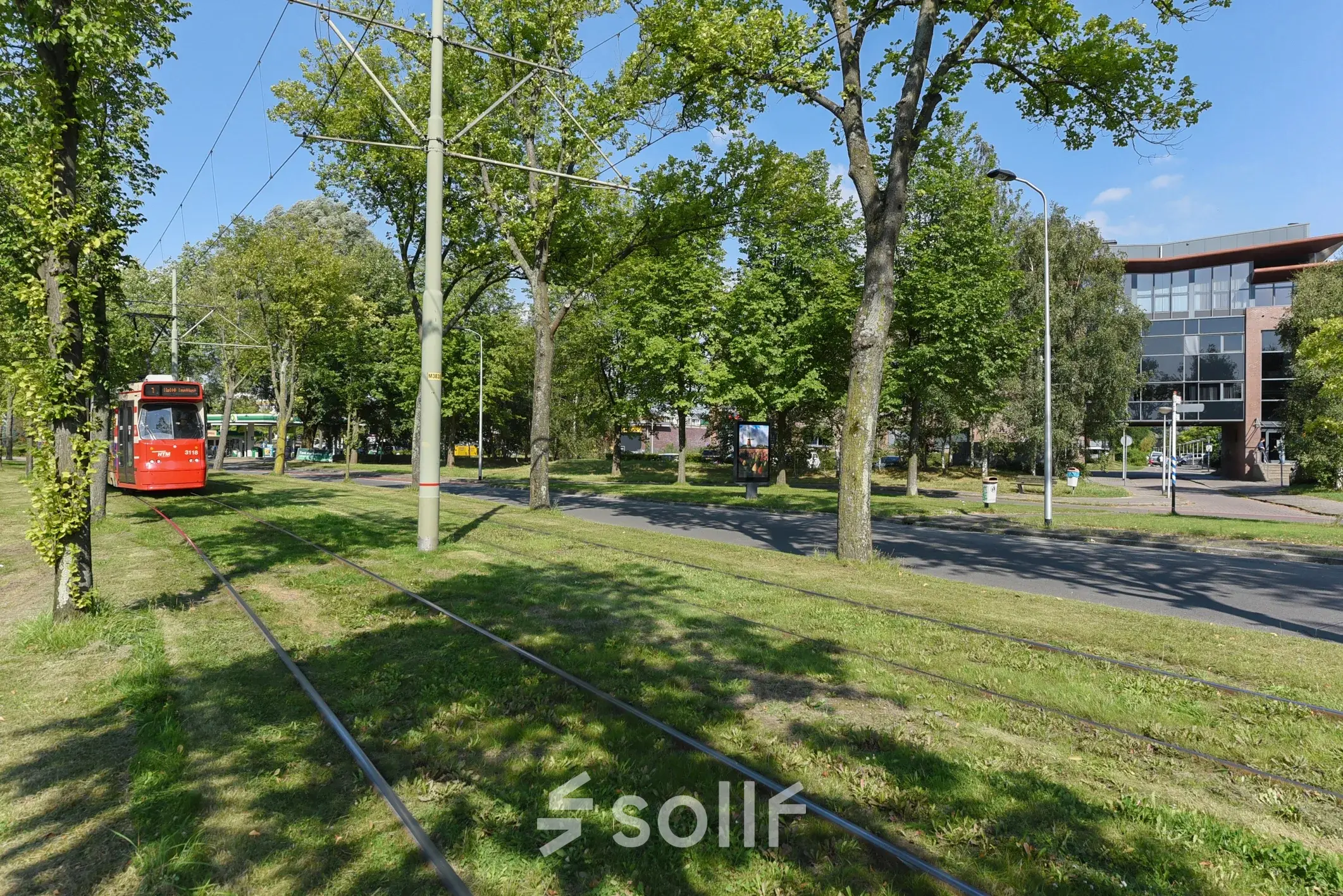 Tram passing by green space near Marshalllaan 2 in Delft, an appealing location for office space rental.