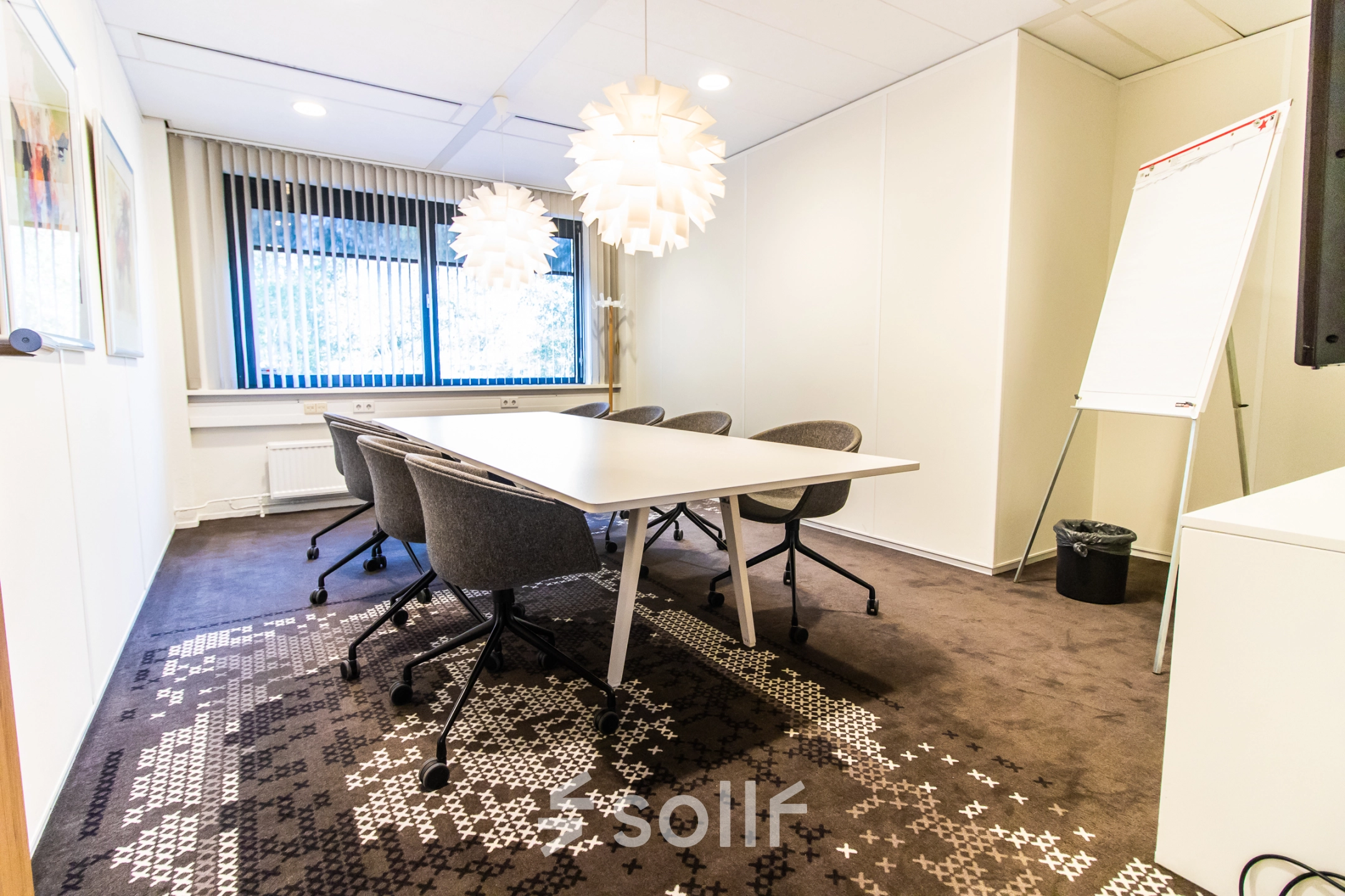 Bright office space rental at Marshalllaan 2, Delft, featuring a modern conference room with stylish lighting and seating. Ideal for businesses seeking an office to rent.
