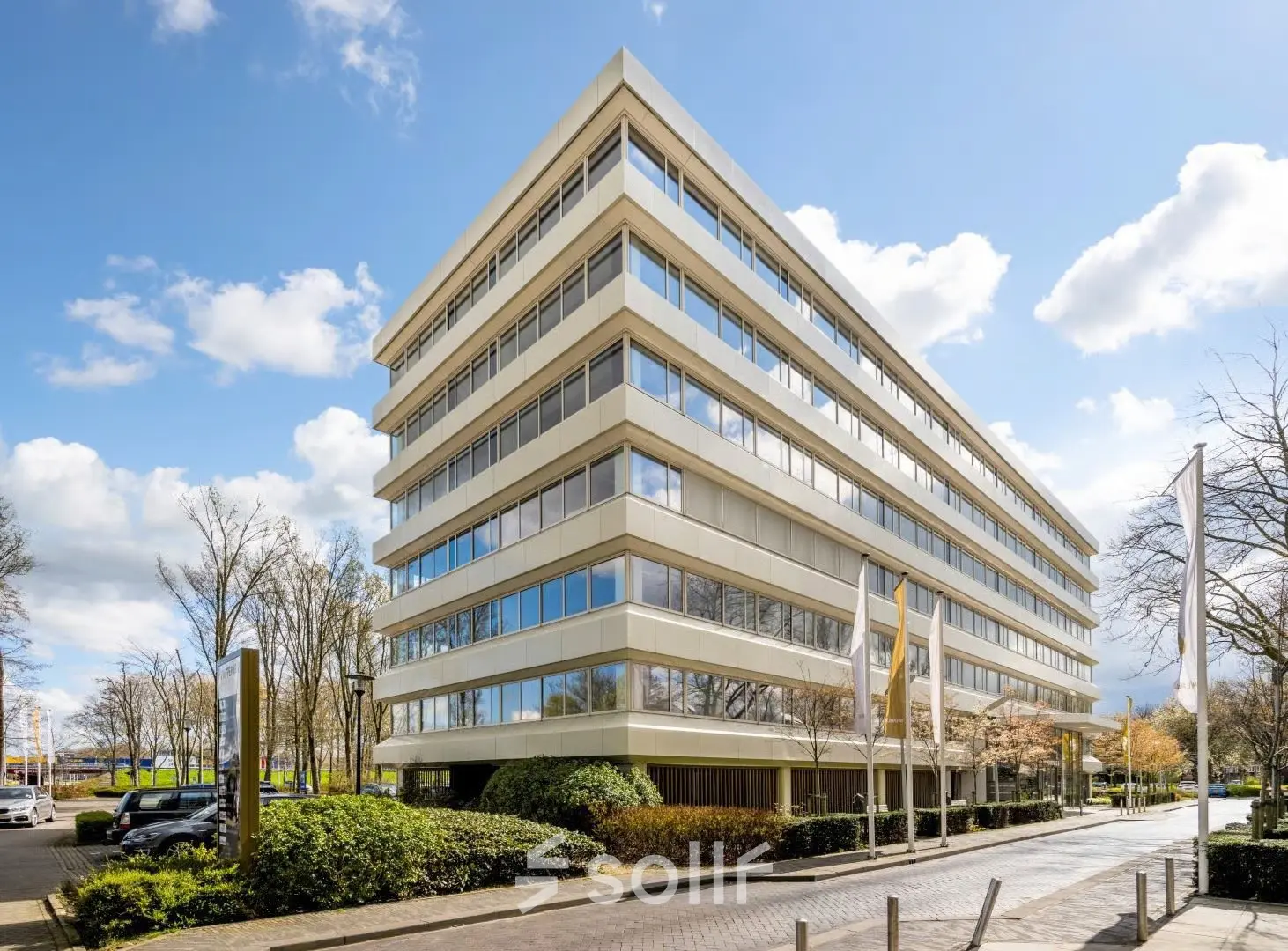 A modern office building located at Poortweg 4 in Delft, ideal for those seeking an office space rental. The exterior showcases multiple windows and well-maintained surroundings.