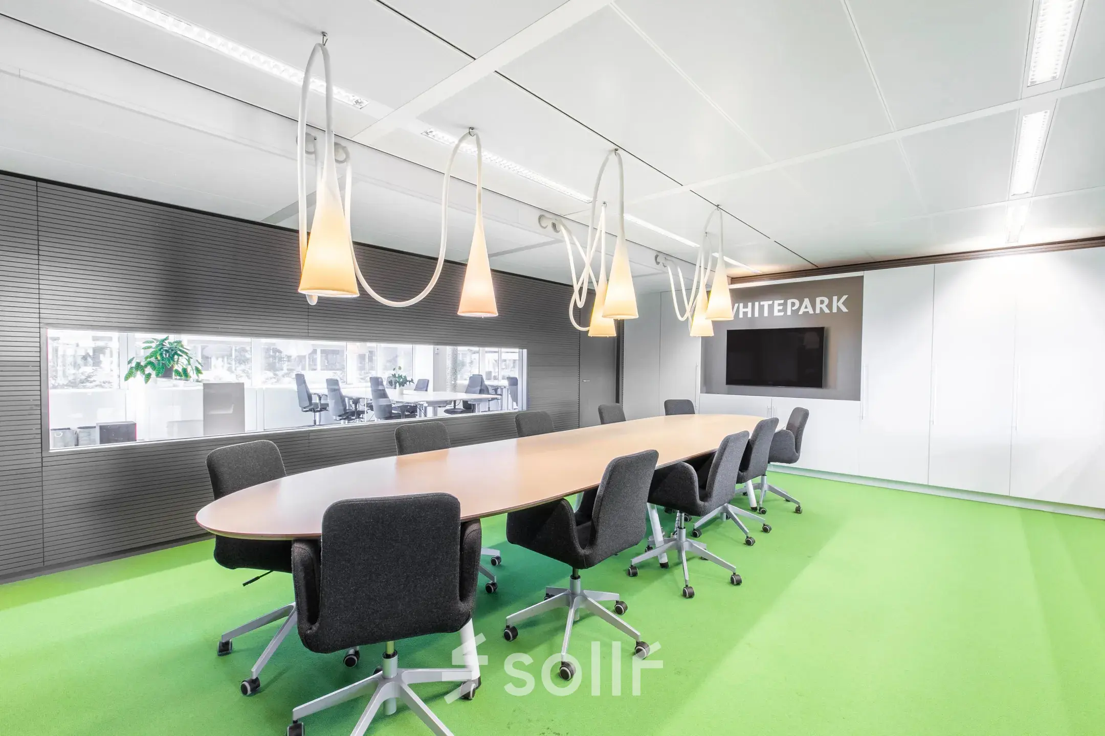 Modern conference room at Poortweg 4, Delft, with a long table, swivel chairs, and ambient lighting, available for office space rental.