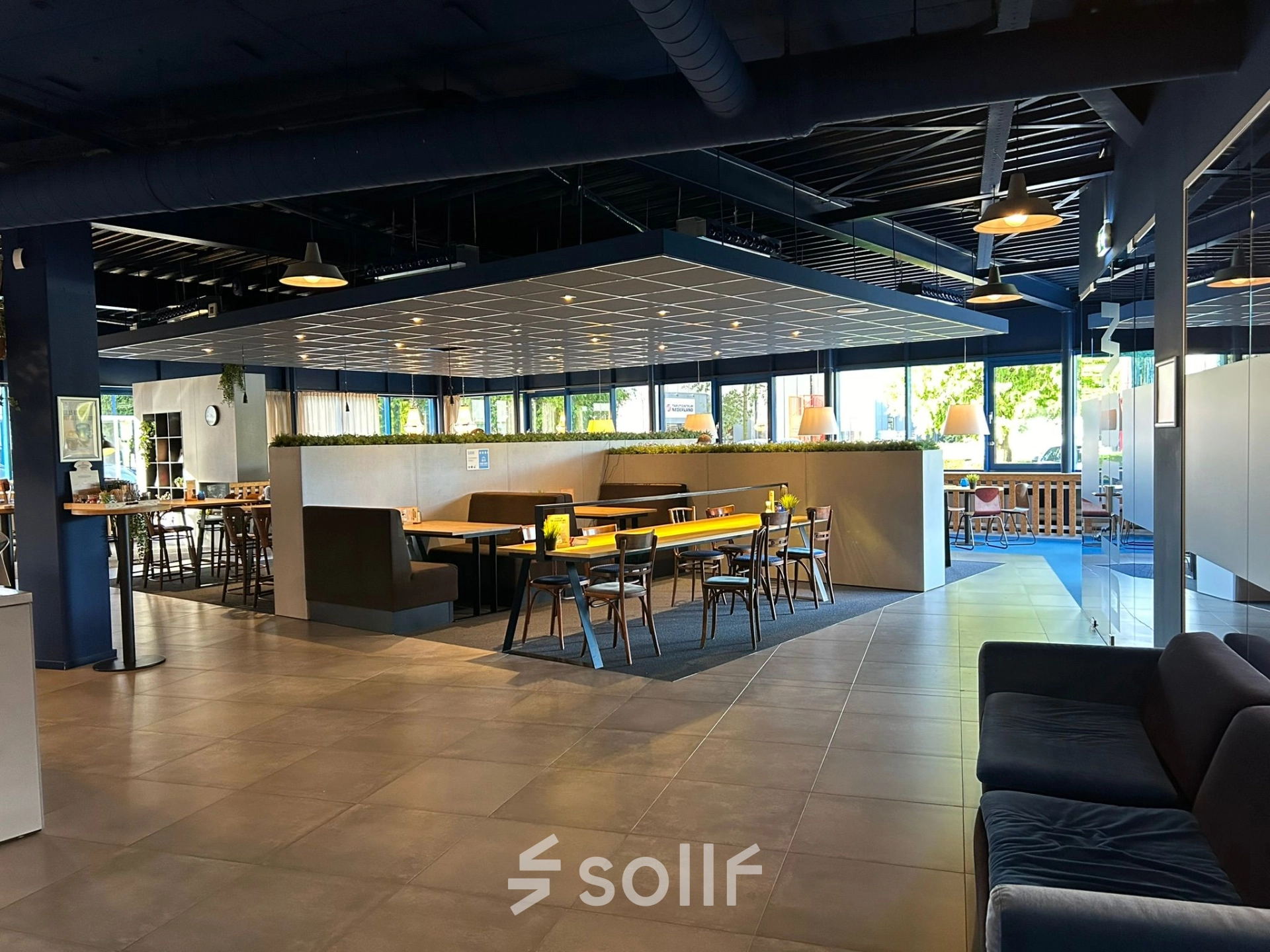 Modern office space at Amerikastraat 3, Den Bosch, featuring open floorplan with stylish furnishings and ample natural light. Ideal for office space rental.