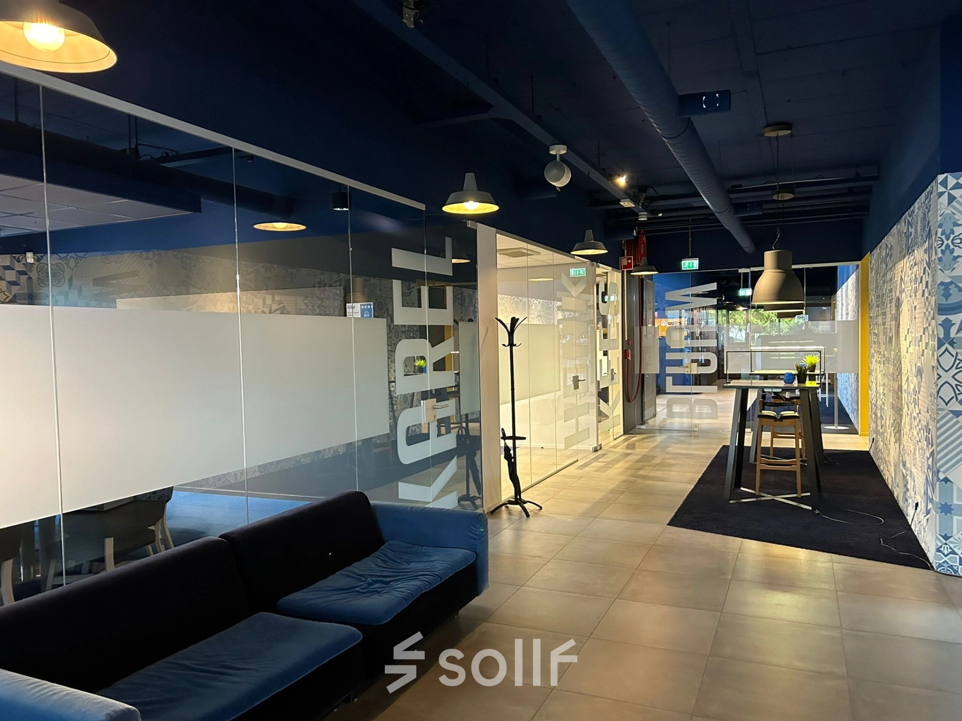 Spacious office interior at Amerikastraat 3, Den Bosch, featuring a modern, open-floor plan with glass partitions and seating areas. Ideal for office space rental.