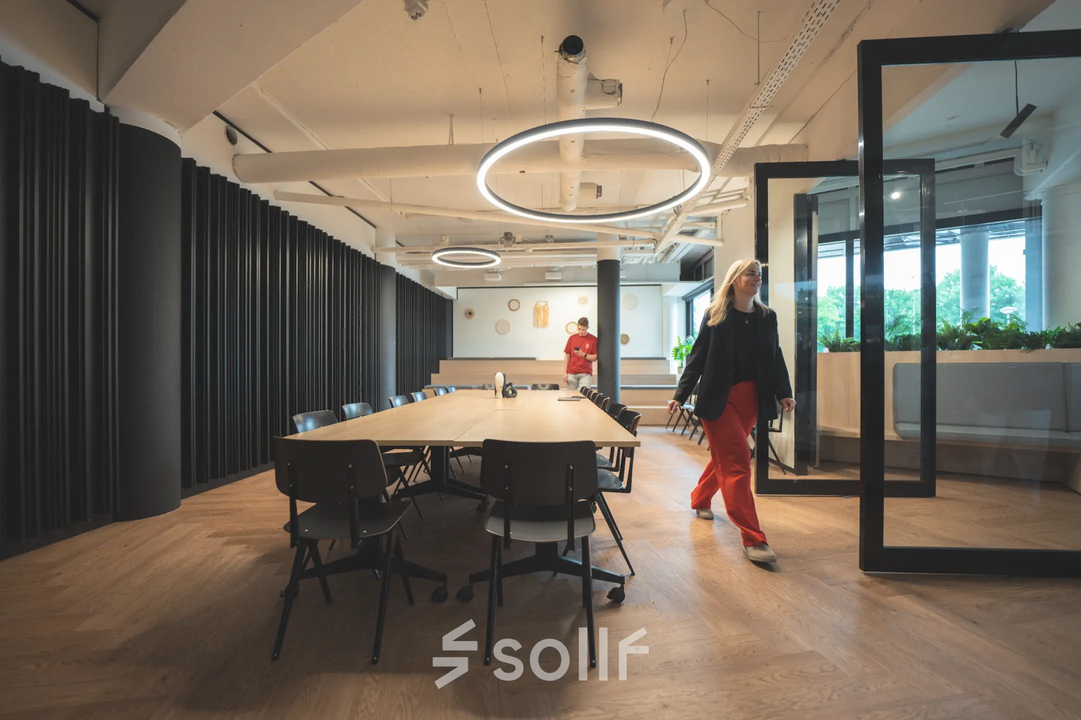 Modern office space at Hambakenwetering 1, Den Bosch, featuring a large table and circular lighting, ideal for office space rental.