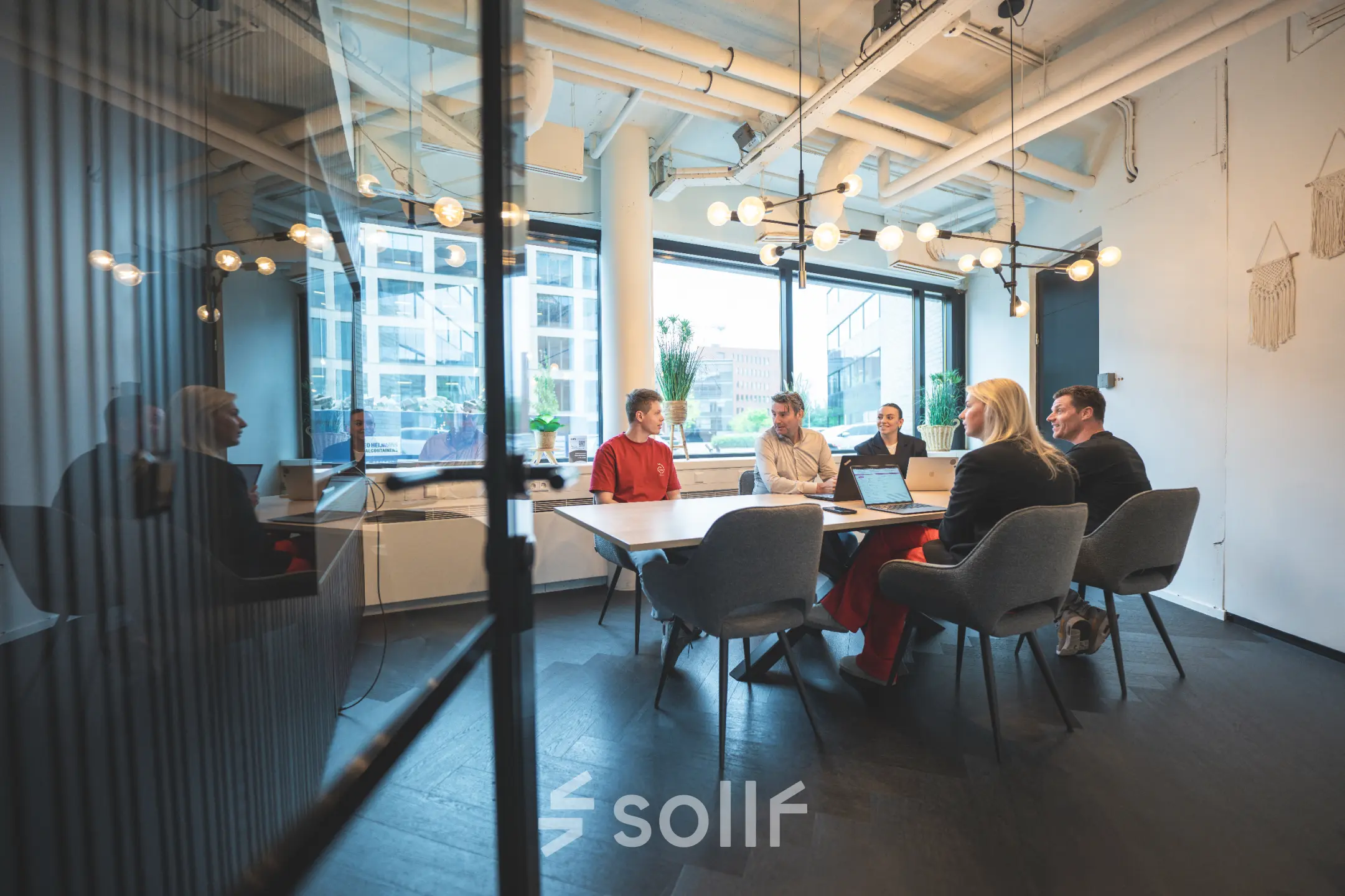 Professionals engaged in a meeting inside a modern conference room at Hambakenwetering 1, Den Bosch, ideal for office space rental.