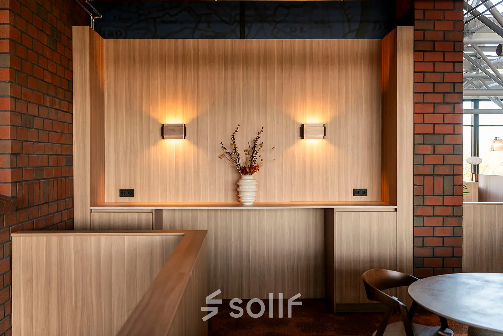 Cozy furnished office space at Hambakenwetering 5 in Den Bosch, featuring warm lighting and a decorative vase on a wooden counter, perfect for office space rental.