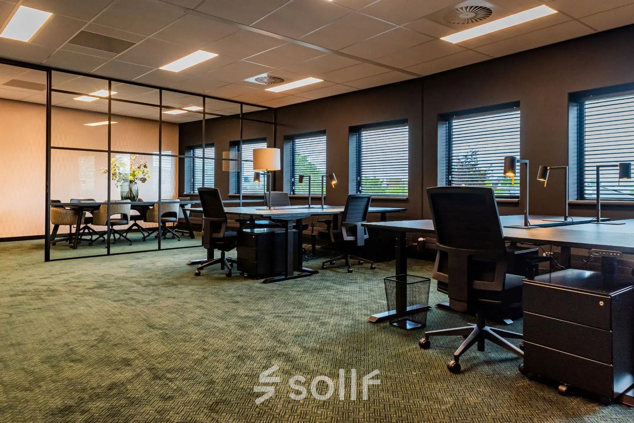 Furnished office space for rent at Reitschweg 1, Den Bosch, featuring desks, chairs, and ample natural light.