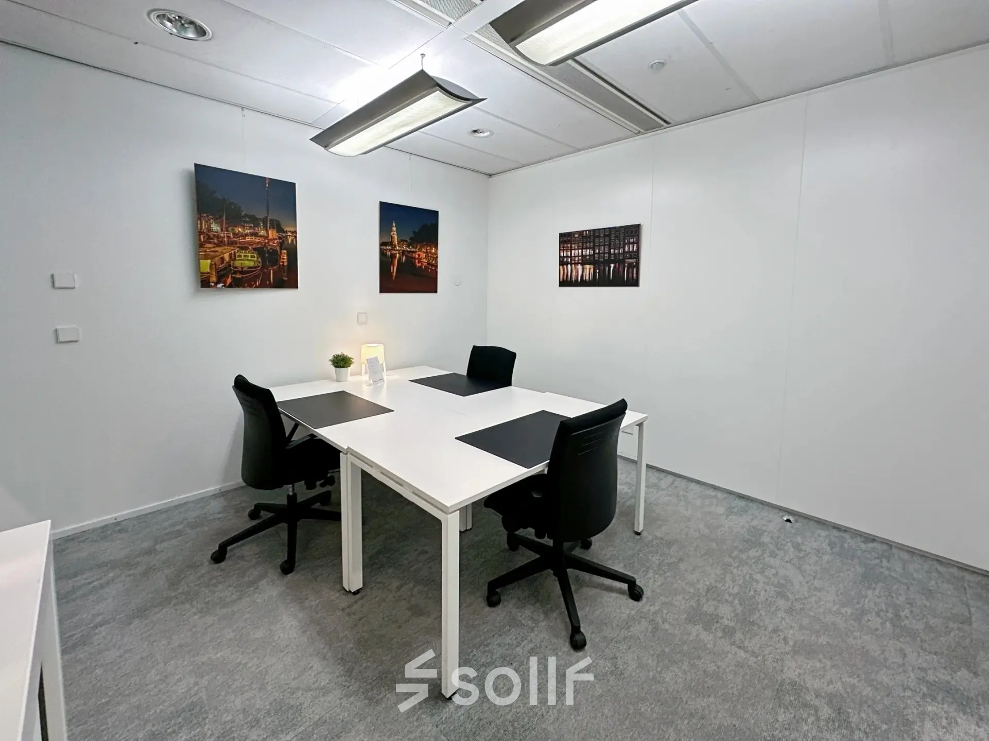 Modern office space for rent at Willemsplein 2, Den Bosch, featuring elegant workstations with black chairs, stylish decor, and minimalistic design.