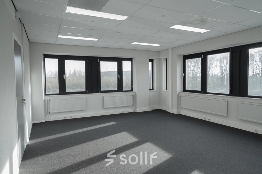Spacious office space for rent at Keulenstraat 1, Deventer, with large windows providing ample natural light.