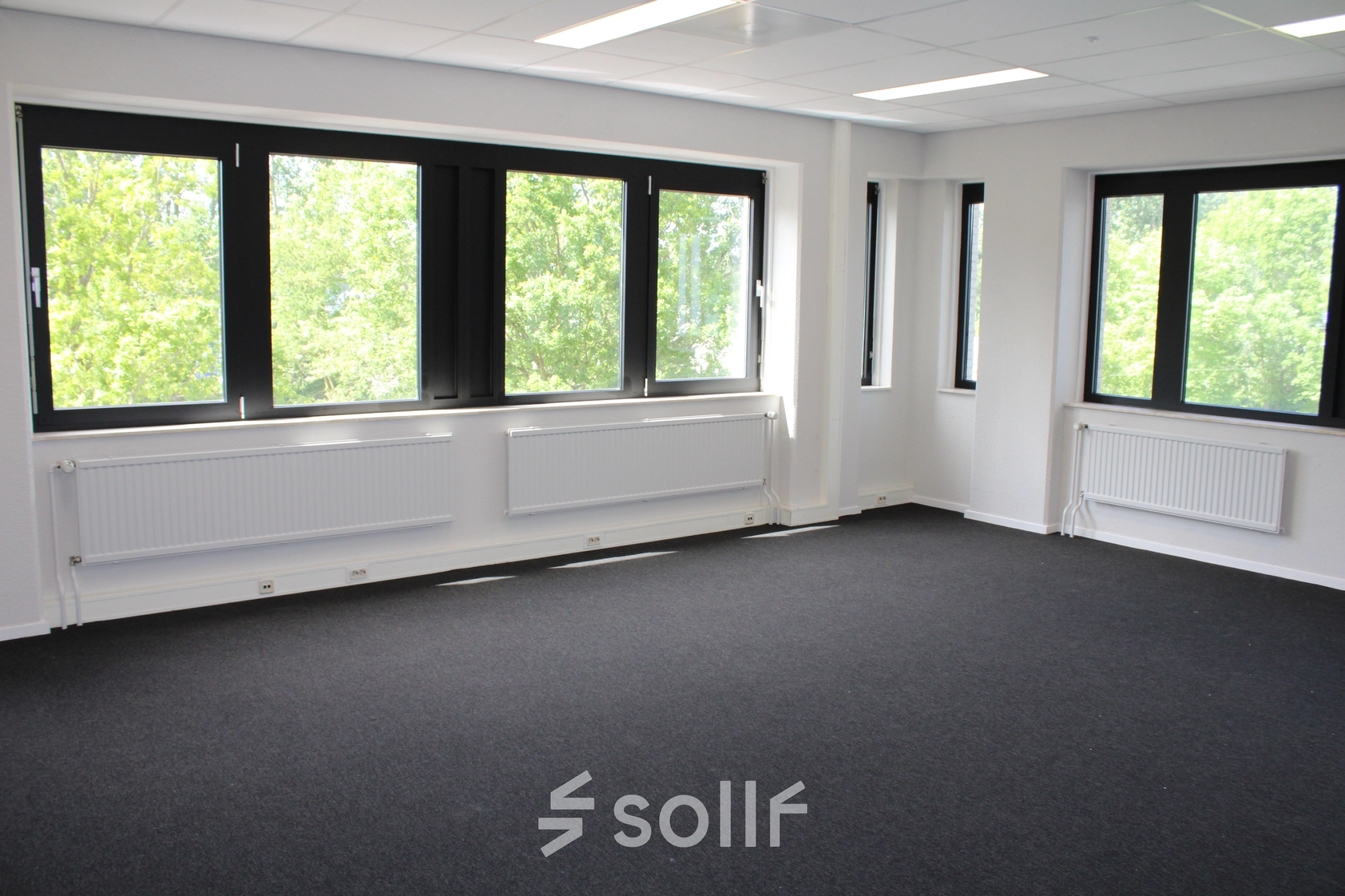 Unfurnished office space with large windows and carpeted floor, ideal for those looking to rent office space in Deventer.