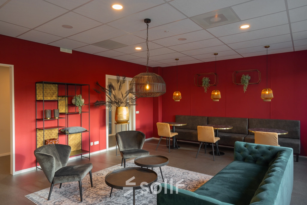 Furnished office space for rent at Keulenstraat 1, Deventer, featuring stylish seating areas with modern decor and ambient lighting.