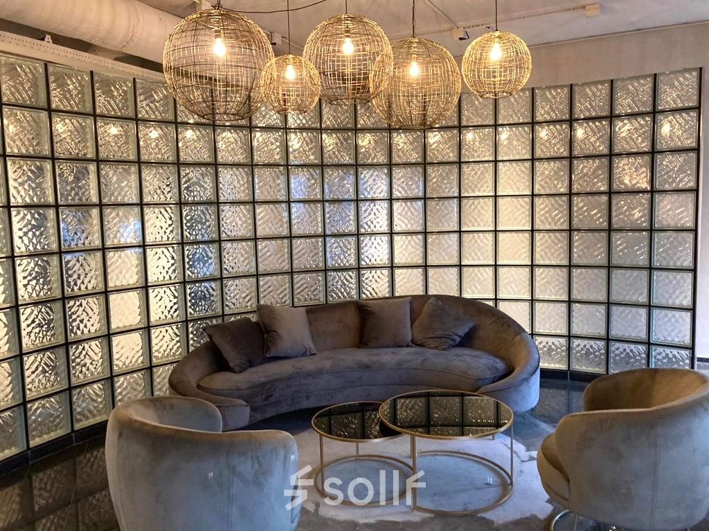 Modern office to rent at Keulenstraat 1, Deventer, featuring stylish seating with plush furniture and chic lighting, ideal for a welcoming reception area. Perfect for office space rental needs.