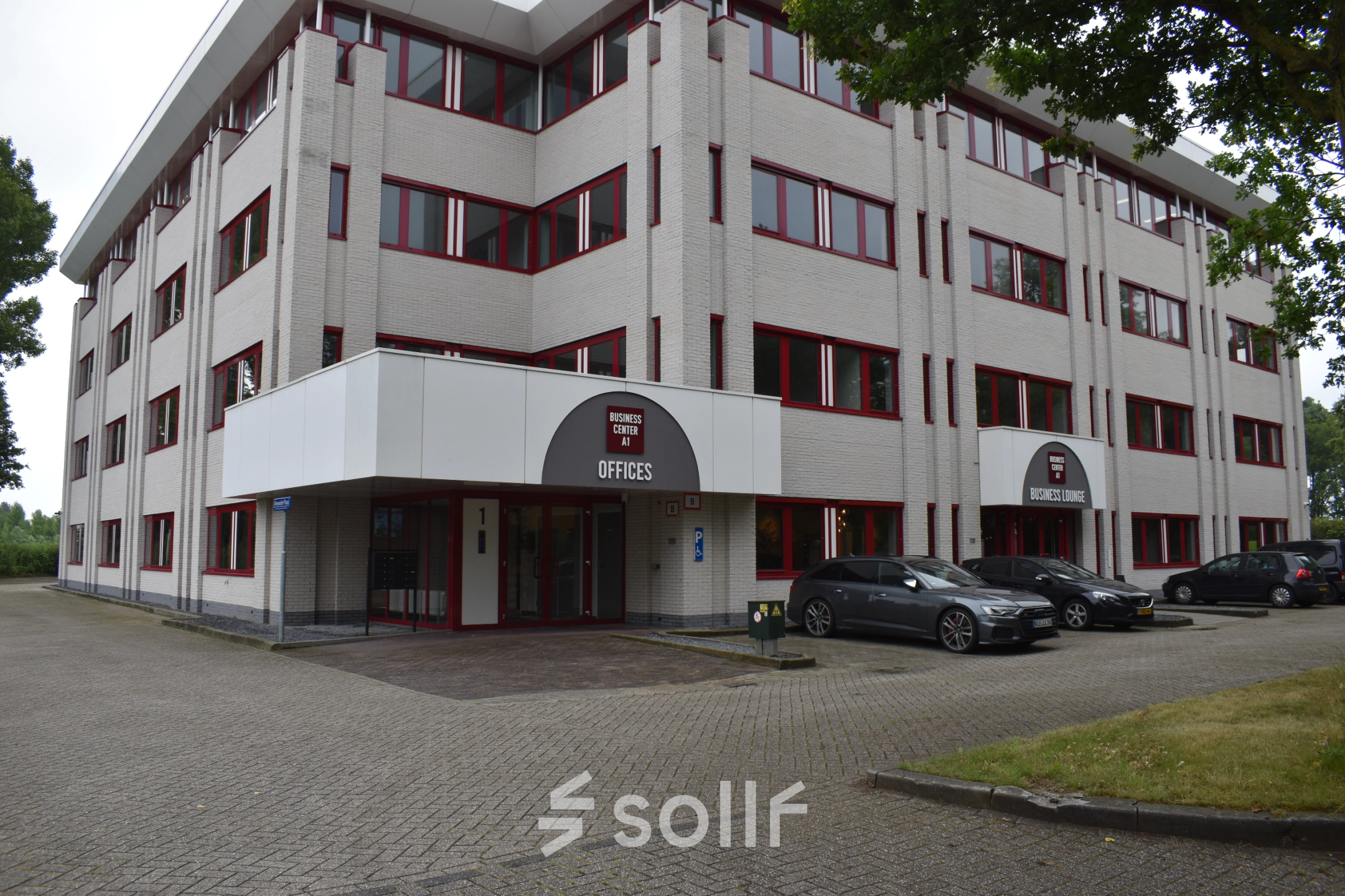 Exterior view of rentable office space at Keulenstraat 1, Deventer. The building features parking spaces and multiple office rental opportunities.
