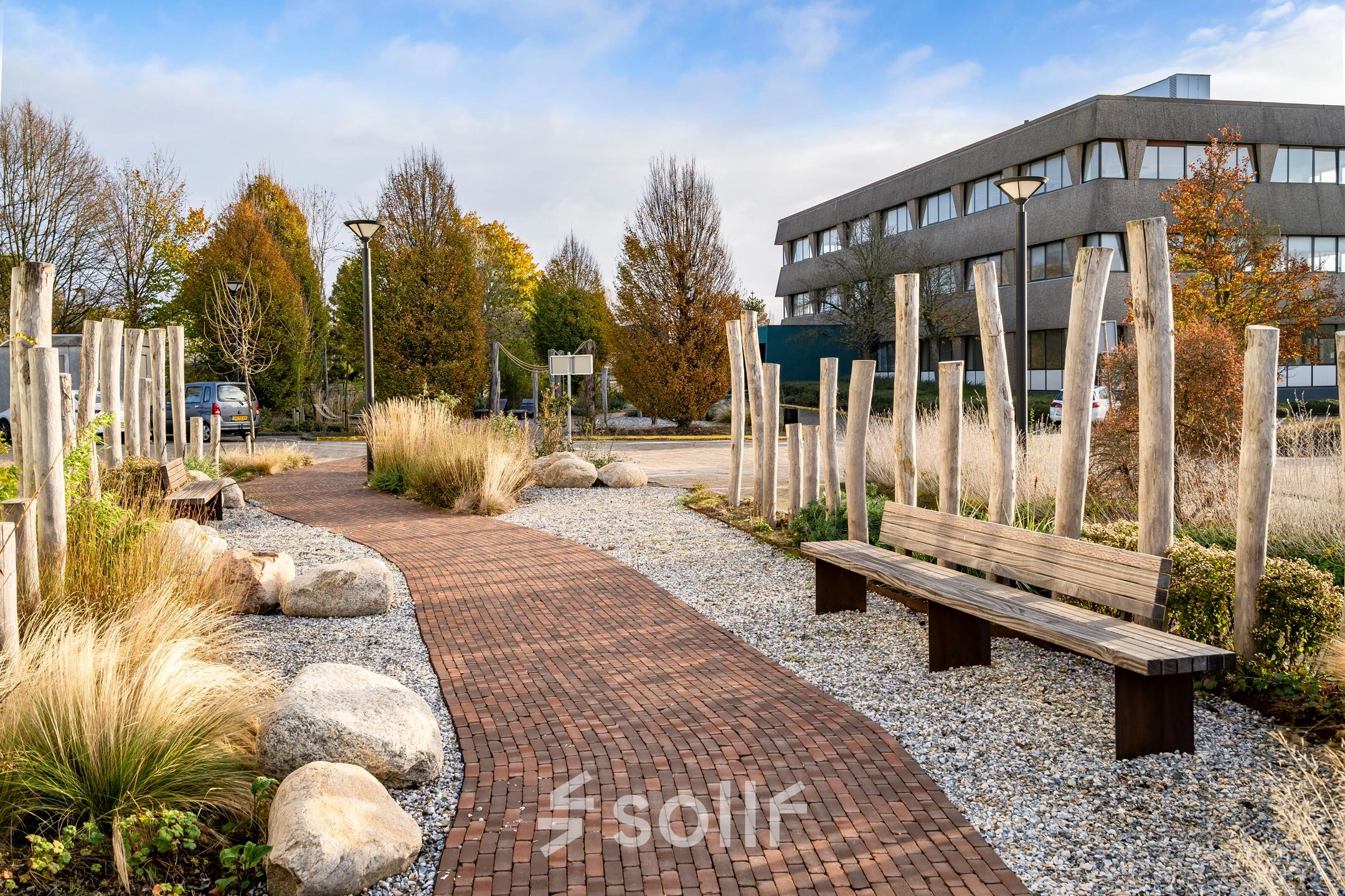 Pathway with benches and landscaping in front of an office building at Staverenstraat 15-17, Deventer, suitable for rent office space.