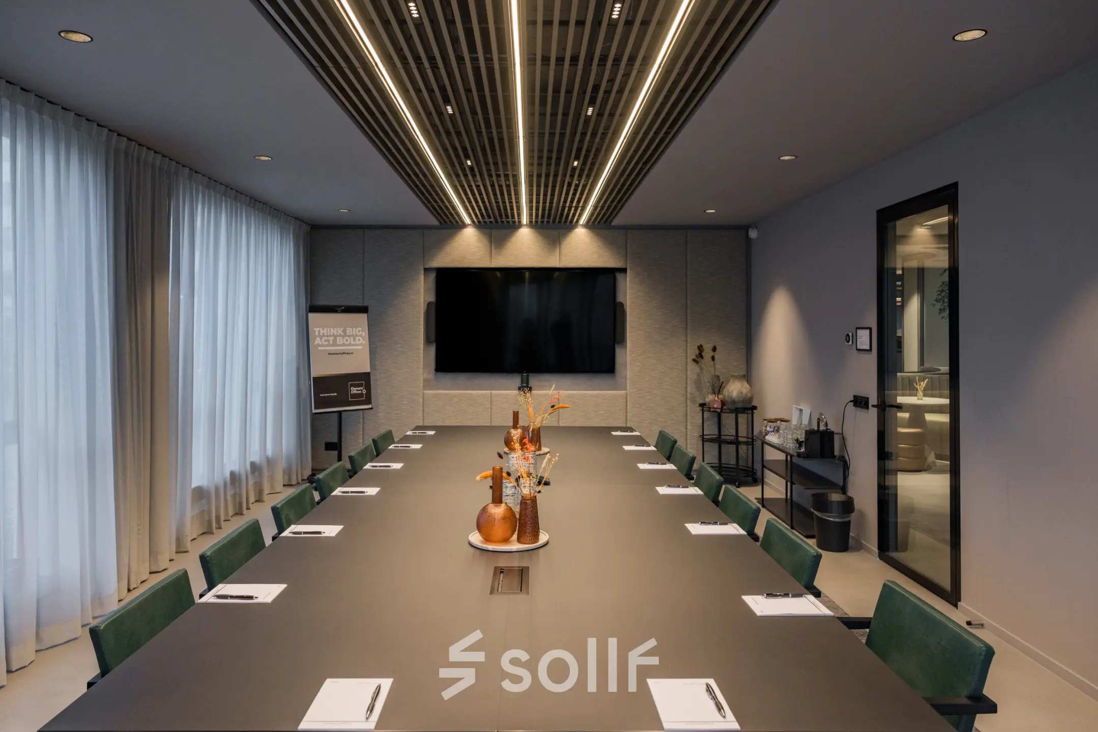A modern conference room at Diemerhof 42, Diemen, available for office space rental. The room features a large table, chairs, and a flat-screen TV, ideal for meetings and presentations.