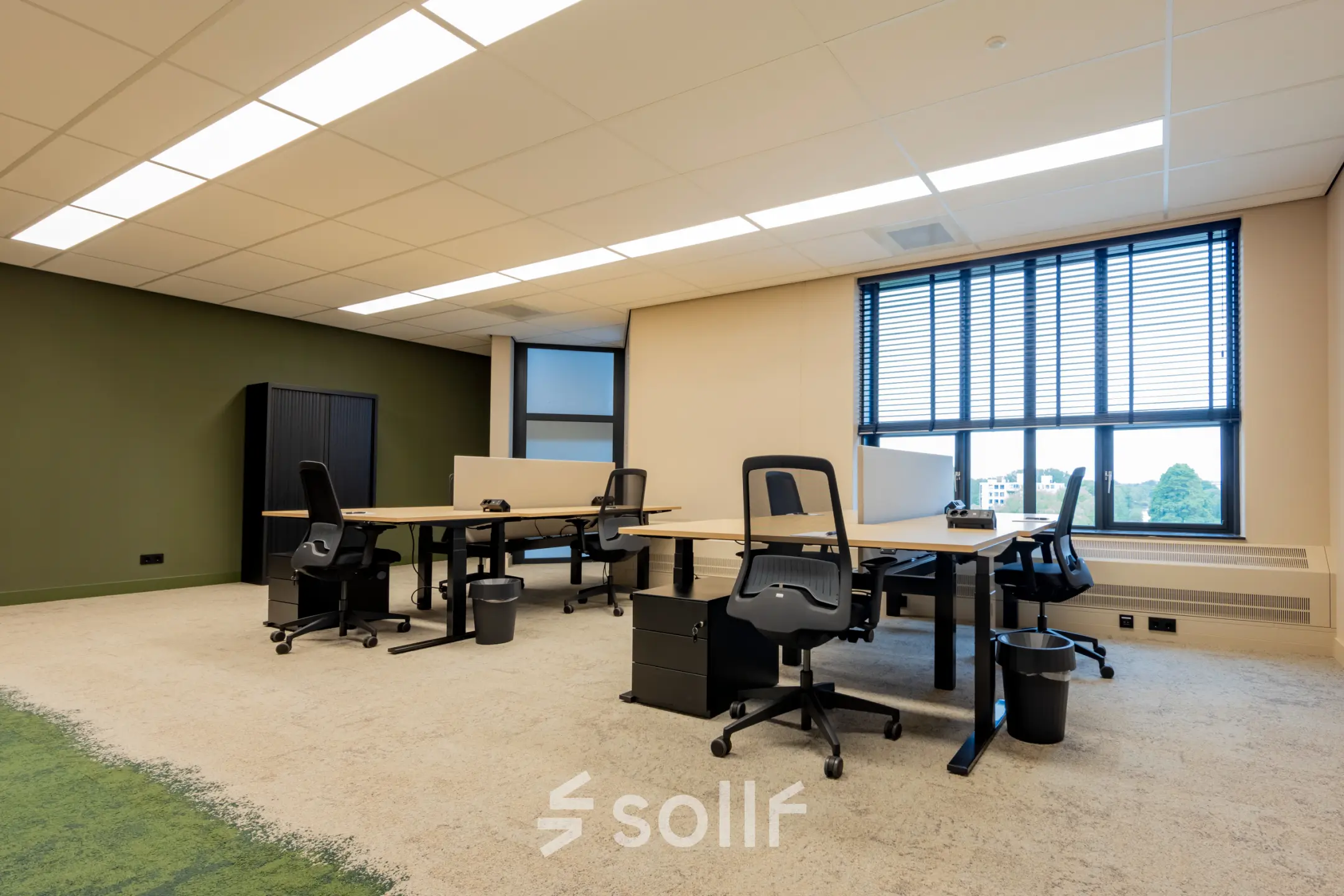Modern furnished office space for rent at Diemerhof 42, Diemen, featuring multiple desks and large windows.