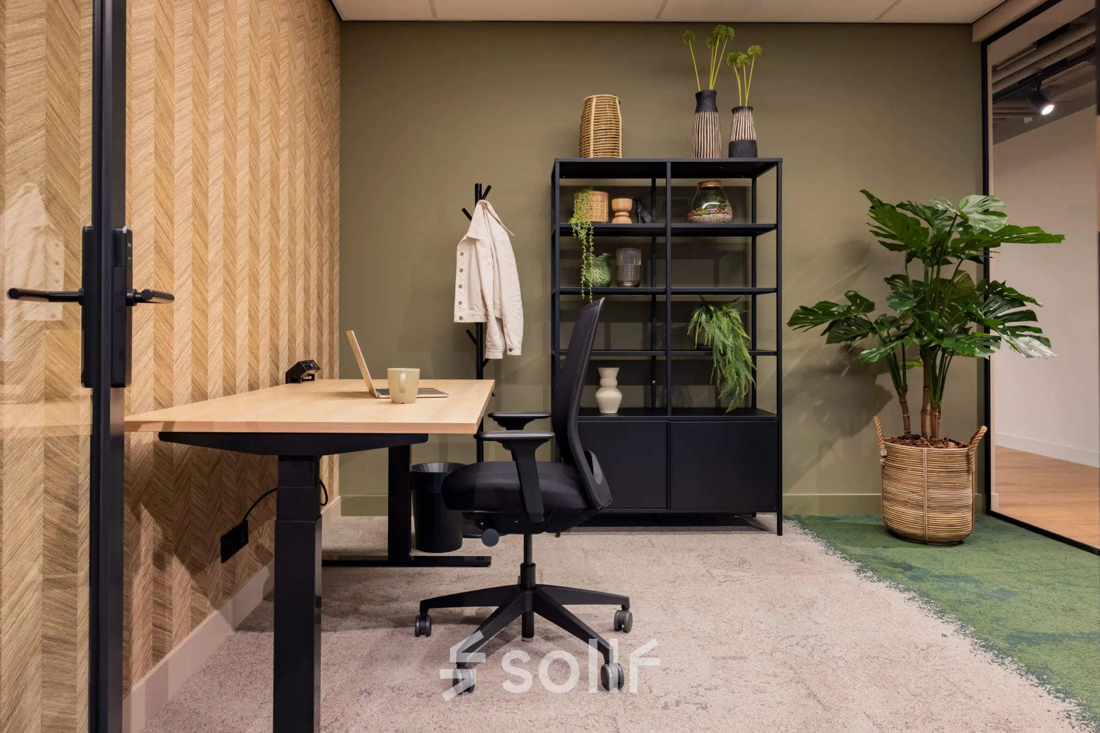 Modern office space for rent at Diemerhof 42, Diemen. Furnished with a desk, chair, and shelving unit, ideal for a productive work environment.