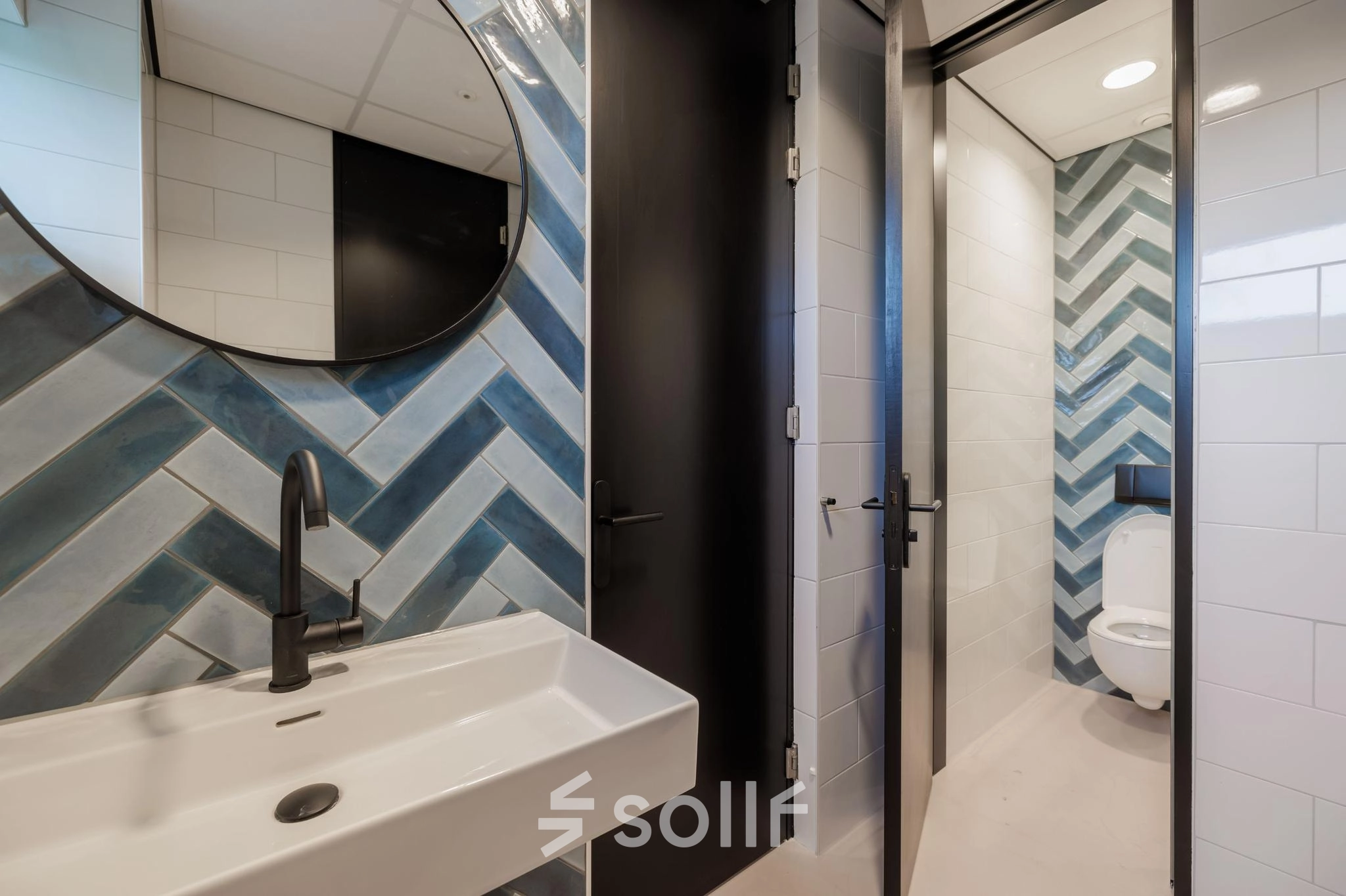 Modern restroom with blue and white tile design at an office space rental, Wisselwerking 40-48, Diemen.