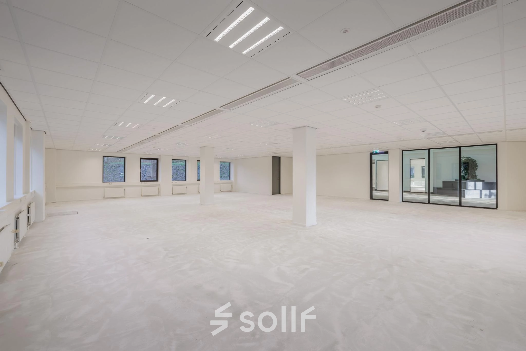 Spacious office space for rent at Wisselwerking 40-48, Diemen, featuring open floorplan with large windows and neutral decor, ideal for flexible office space rental.