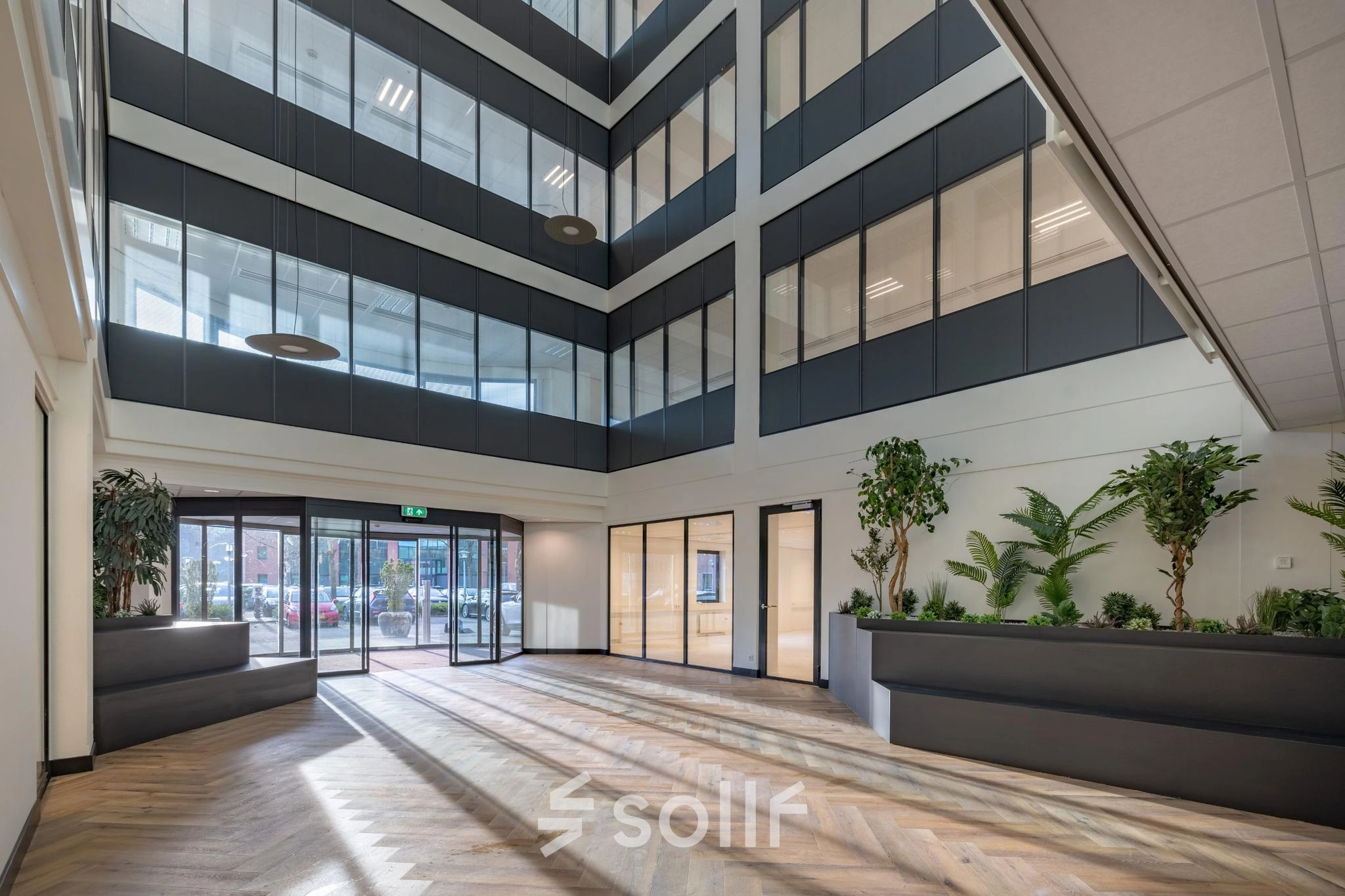 Interior view of an office space at Wisselwerking 40-48, Diemen with large windows, modern decor, and hardwood floors. Ideal for office space rental.