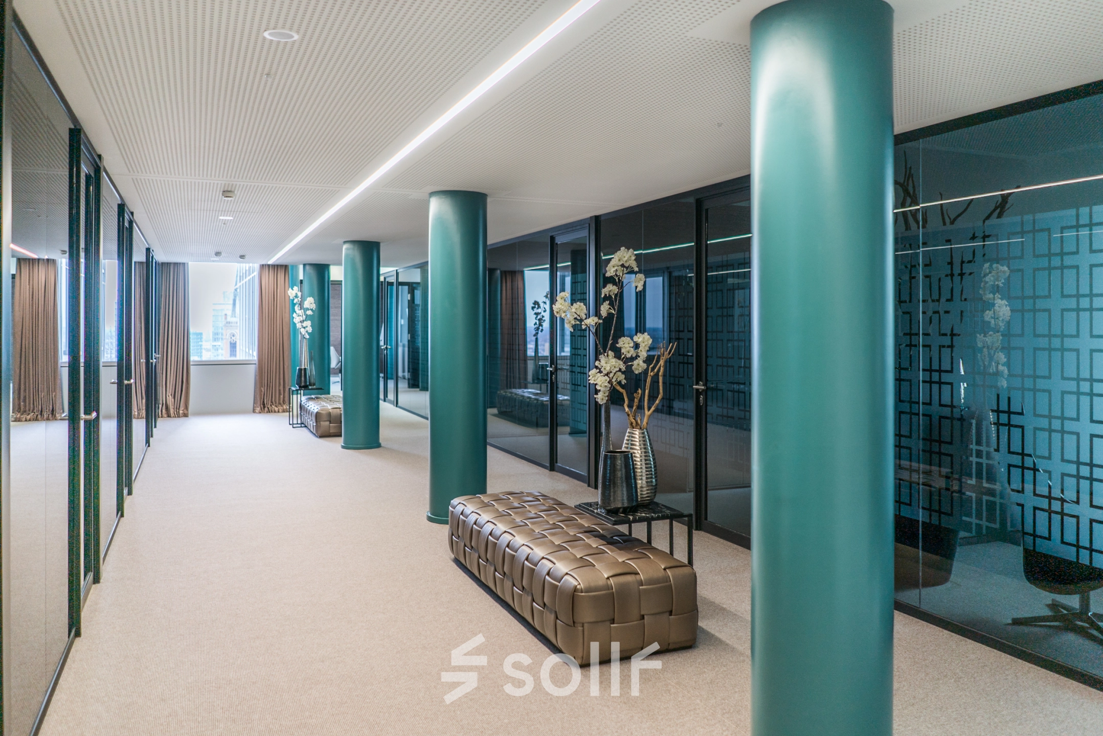 A sleek hallway in Dreischeibenhaus, Düsseldorf, ideal for office space rental with stylish decor and modern glass accents.