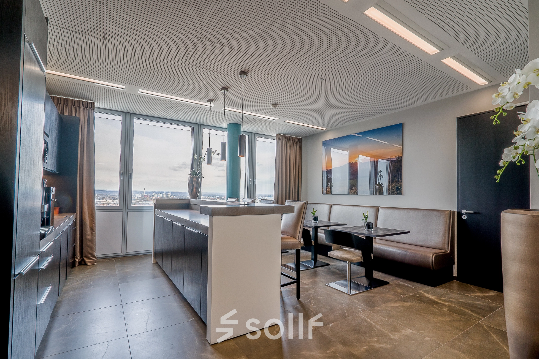 Bright office space to rent at Dreischeibenhaus 1, Düsseldorf Old Town, featuring a cozy seating area with a city view, perfect for office space rental.