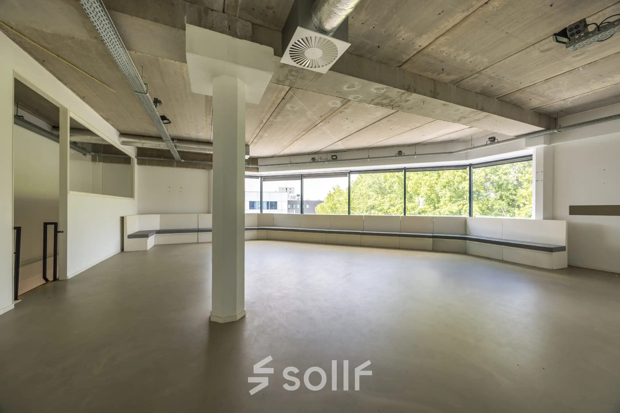 Spacious office space at Luchthavenweg 81 with large windows and concrete ceiling, ideal for rent office space.