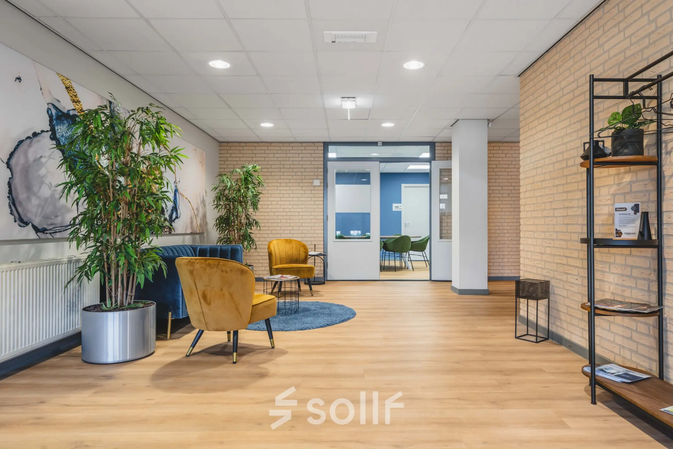 Bright office space with comfortable seating and plants, available for rent at Kanaaldijk-Zuid 19, Eindhoven Center, showcasing an inviting atmosphere for office space rental.