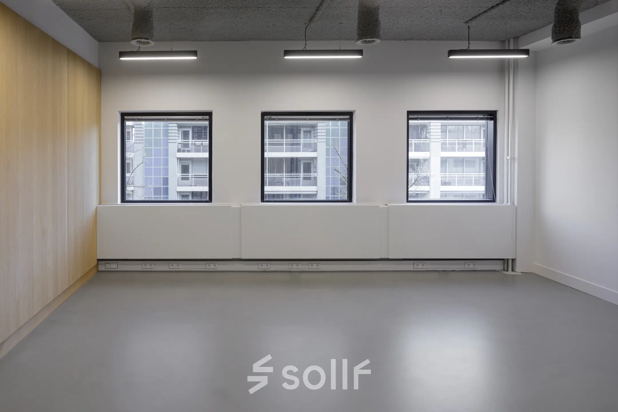 Spacious and bright office space for rent in Eindhoven Center with large windows and modern lighting.